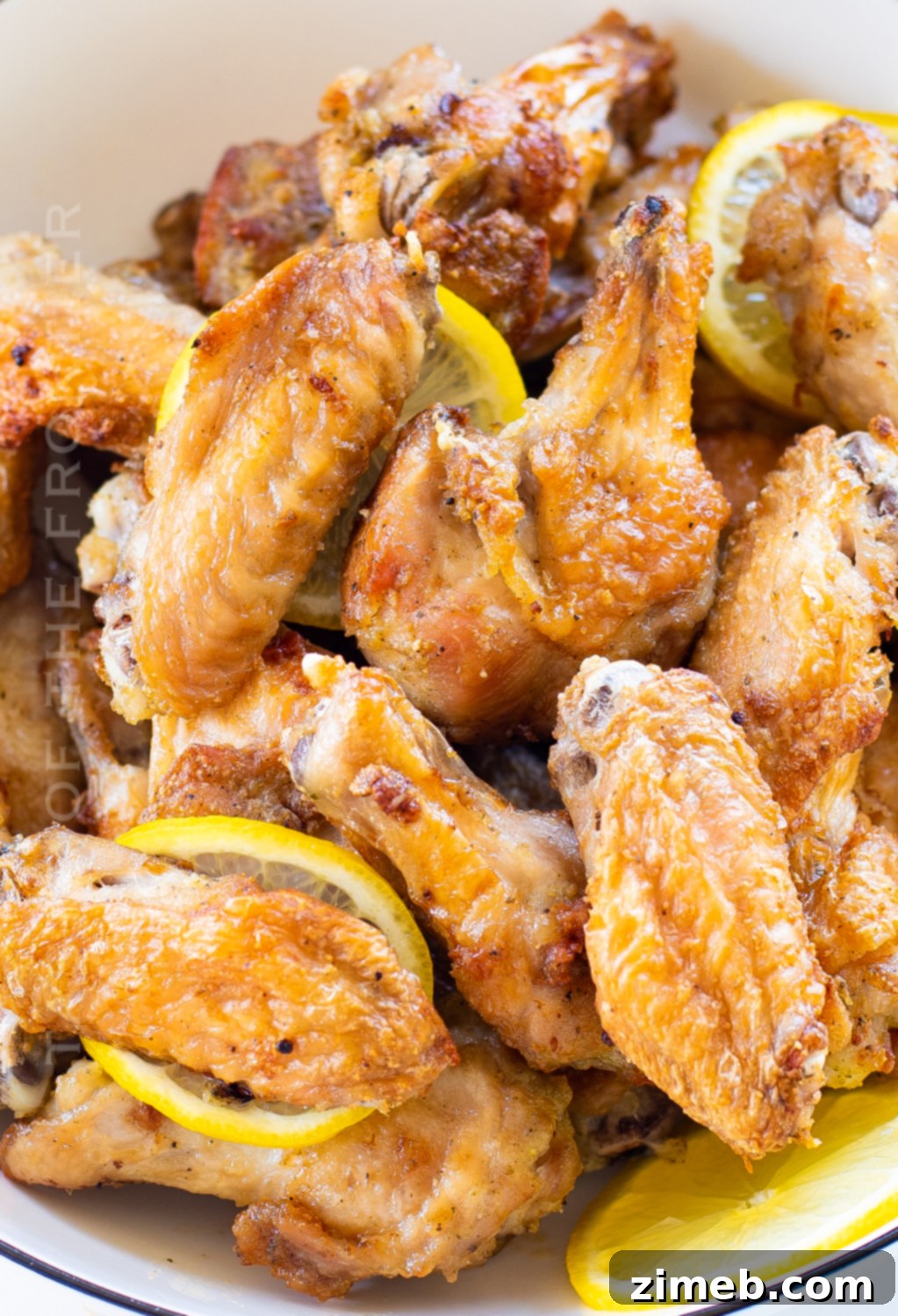 Air Fryer Lemon Pepper Wings 4 Close-up of golden brown air fried lemon pepper chicken wings.