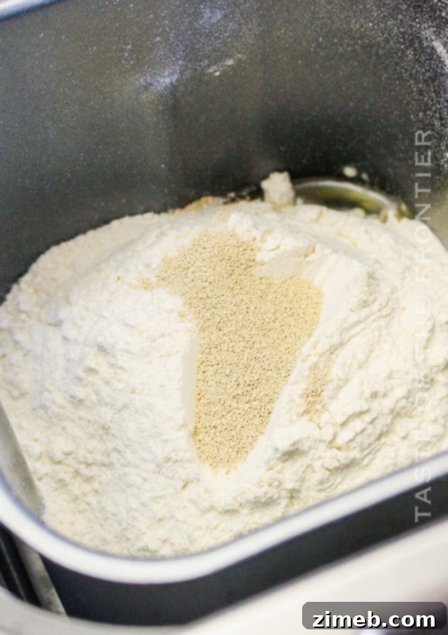 Perfect Bread Machine White Bread 6 Bread dough rising in a bread machine pan.