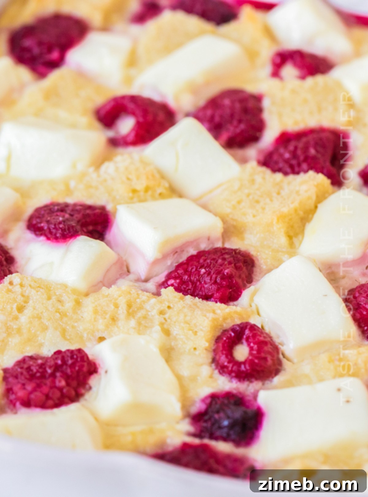 Overnight French Toast Casserole with Raspberries, showcasing its beautiful layers before baking, perfect for a special breakfast.
