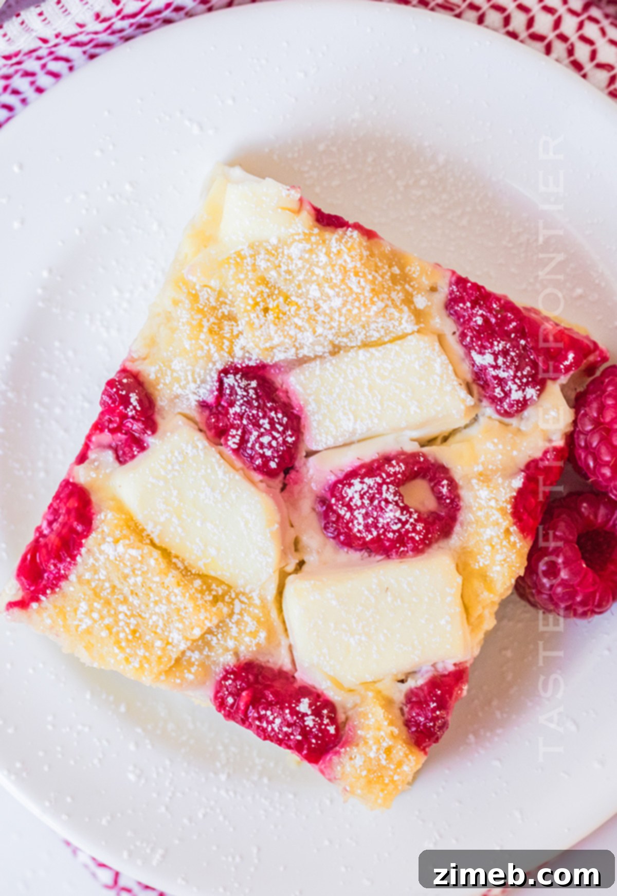 Cream Cheese Raspberry Casserole, a close-up of the delicious baked casserole, highlighting its creamy and fruity components.