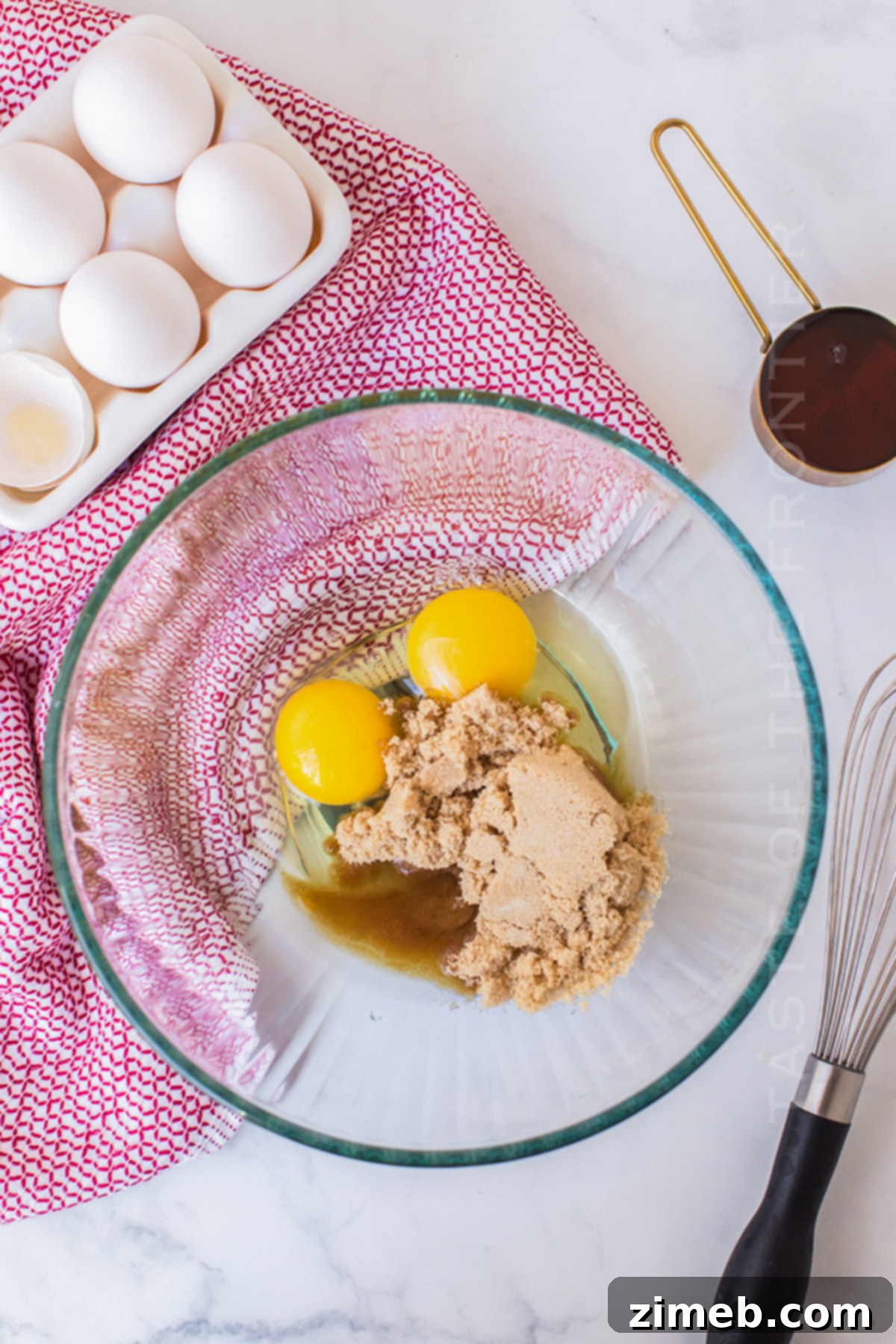 Mixing the egg and sugar mixture for the Easy French Toast Casserole, a crucial step in preparing the rich custard.