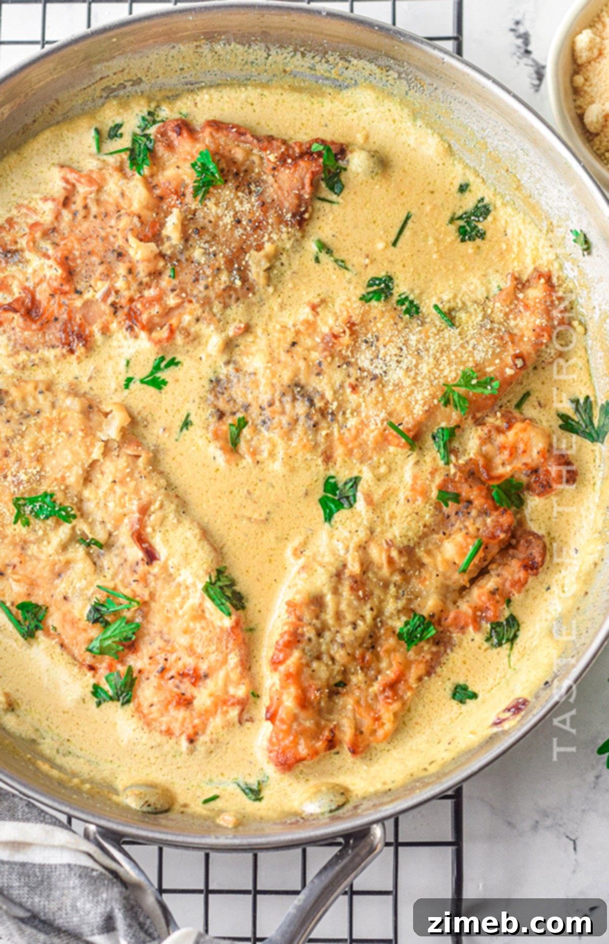 Dreamy Creamy Air Fryer Garlic Chicken 10 Making creamy garlic sauce for chicken in a pan.