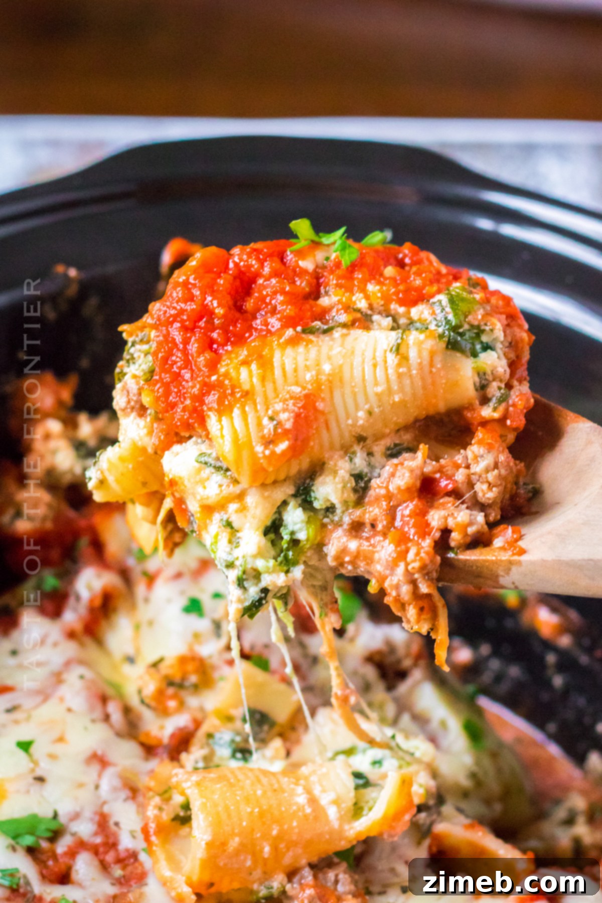Set It and Forget It Stuffed Shells 17 Serving slow cooker stuffed shells, with parmesan and parsley garnish