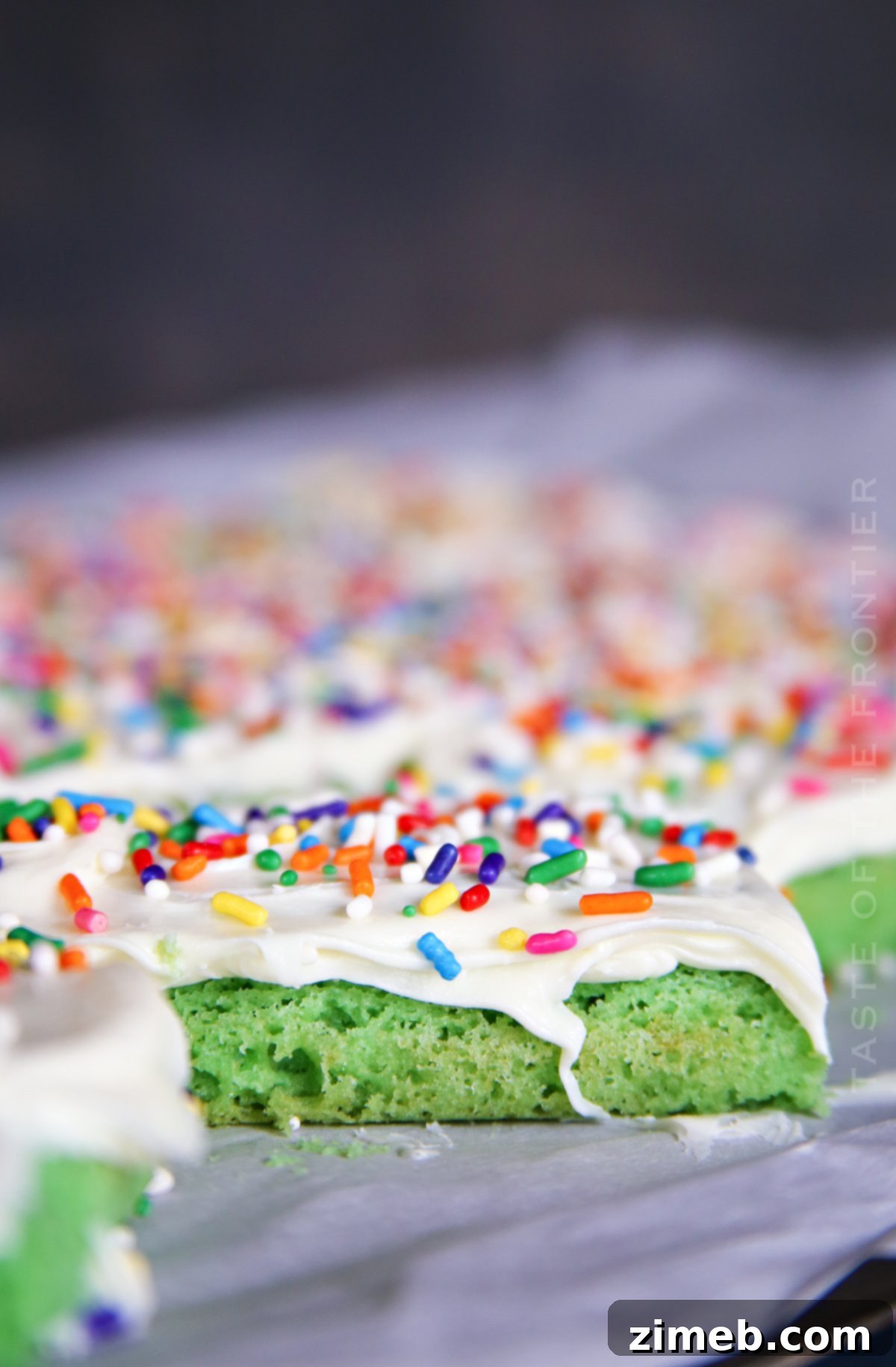 Lucky St Patricks Day Cake Mix Cookie Bars 3 Close-up of vibrant green St. Patrick's Day Bars with creamy frosting and colorful sprinkles.