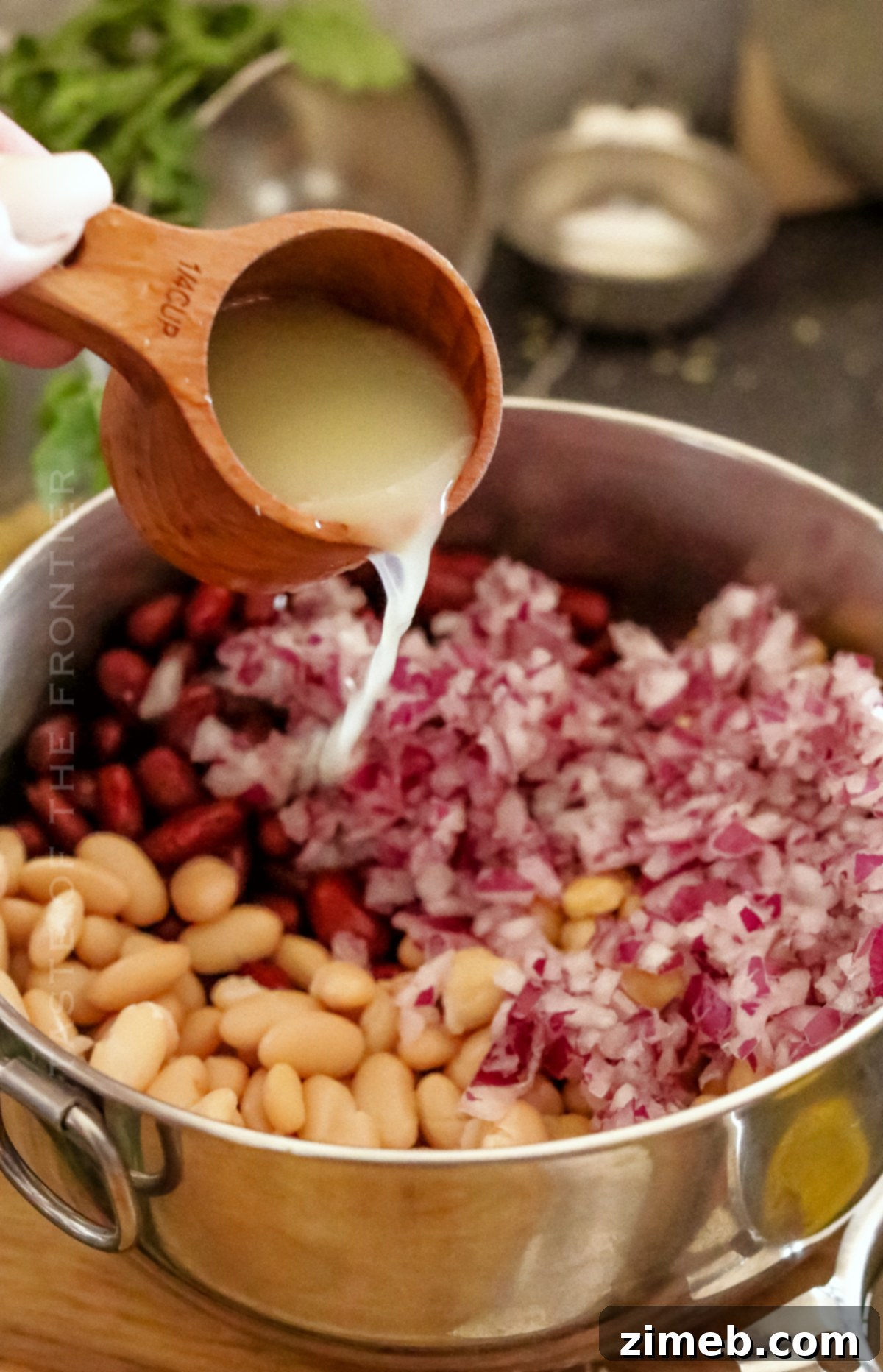 A close-up of a serving of 3 bean salad in a bowl, showing the colorful mix of beans and dressing.