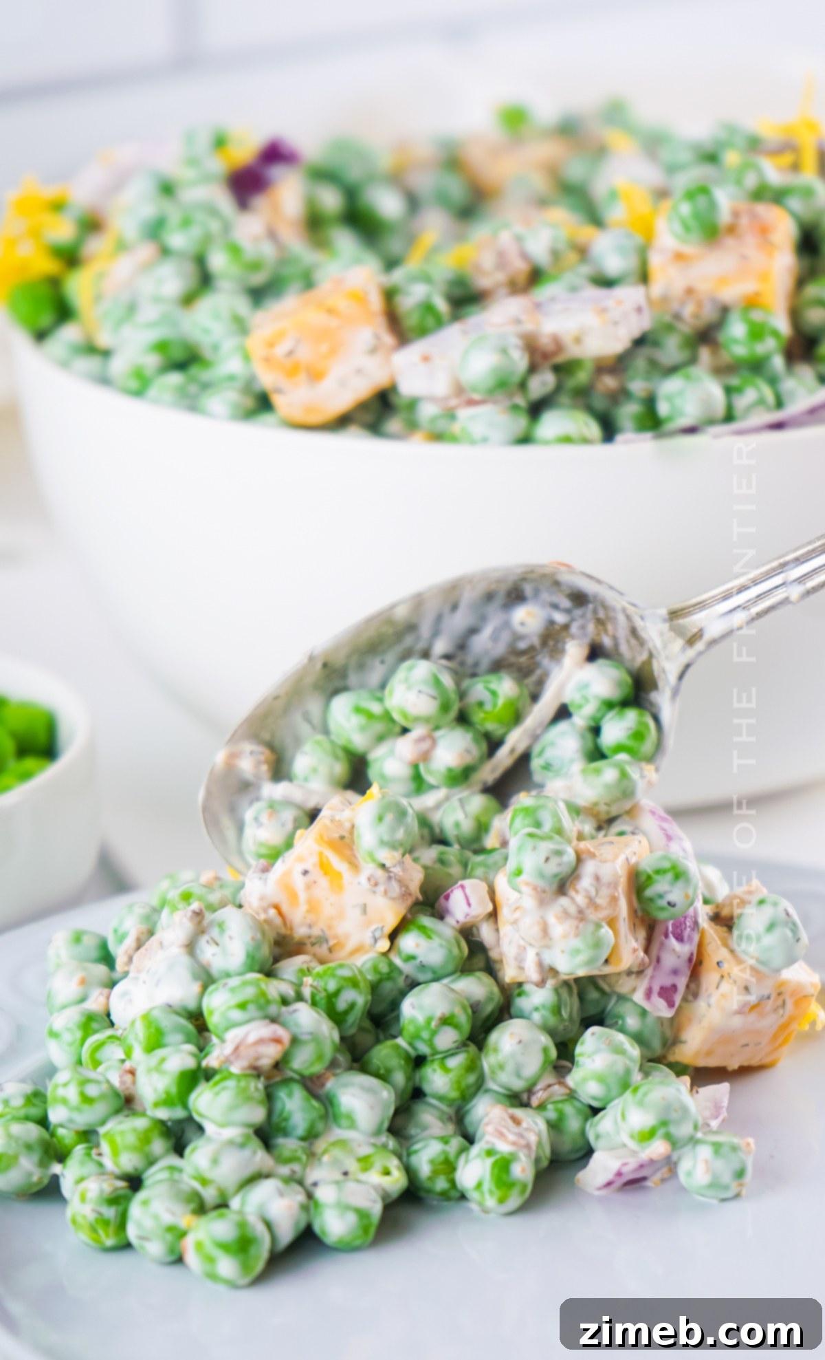 Refreshing Pea Salad 18 A bowl of fresh English pea salad with herbs and a creamy dressing, ready to serve.