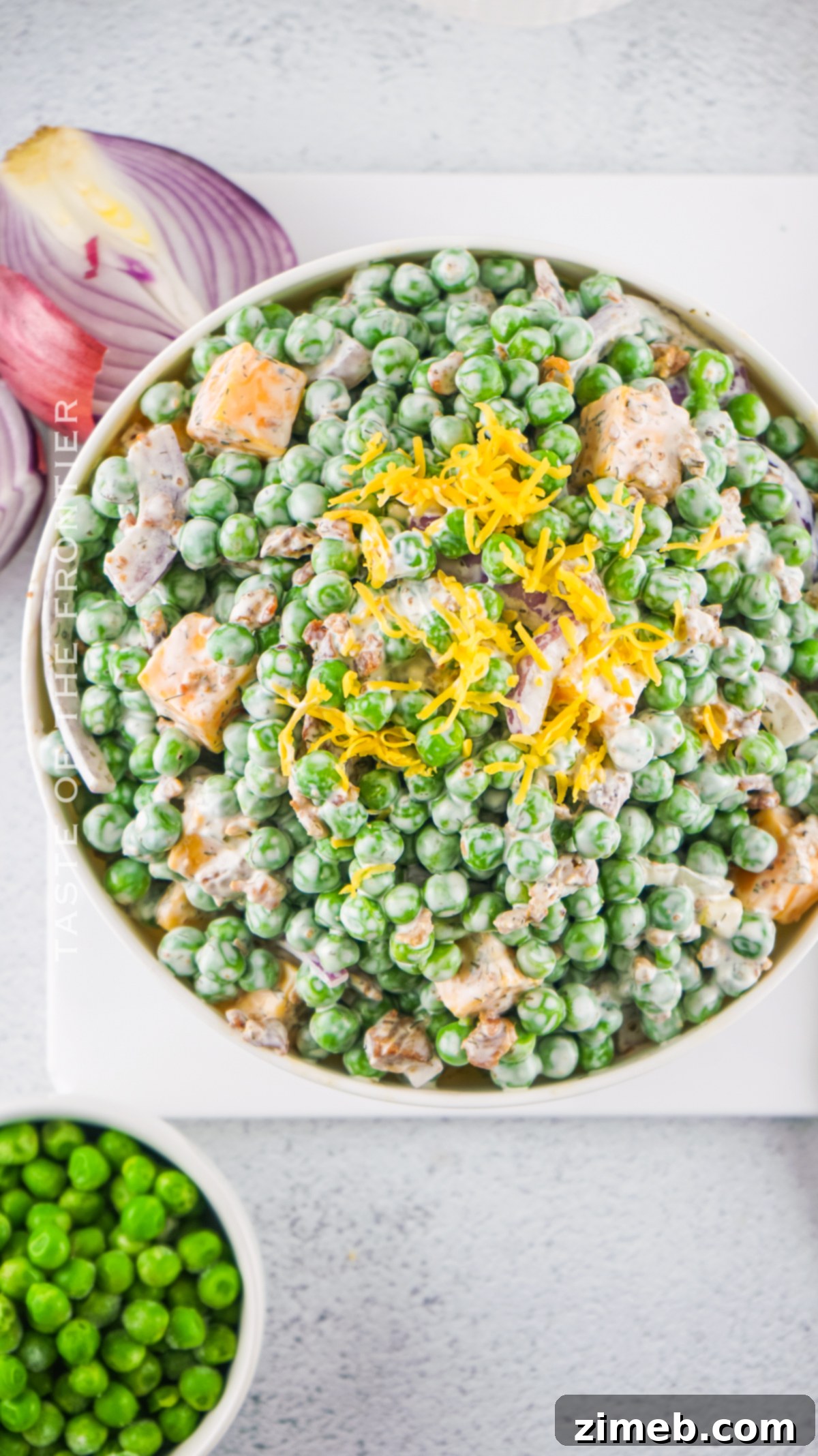 Refreshing Pea Salad 19 A rustic, old fashioned pea salad served in a clear bowl with serving spoon.