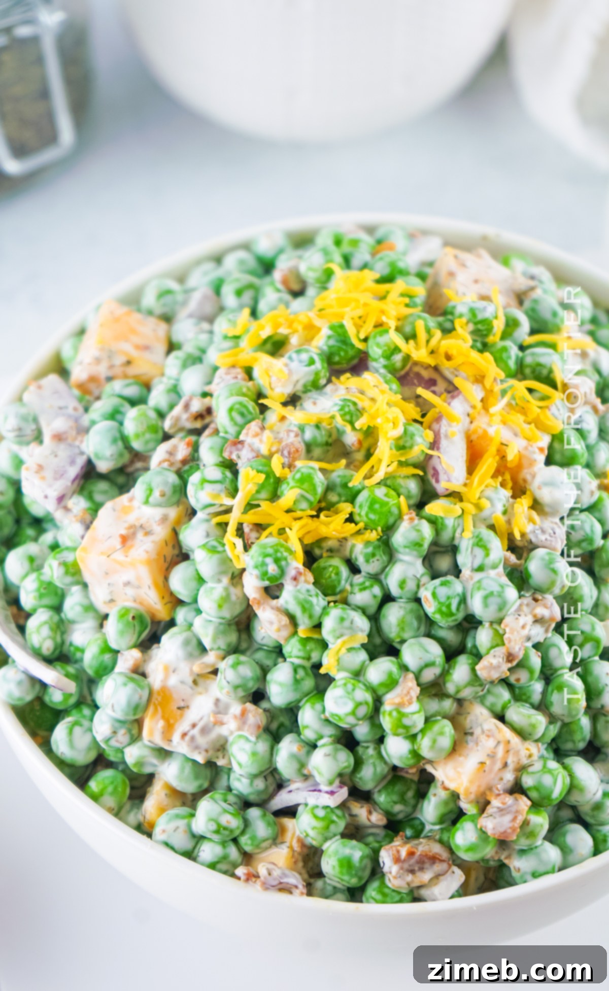 Refreshing Pea Salad 3 Green Pea Salad as a vibrant summer side dish on a wooden table outdoors.