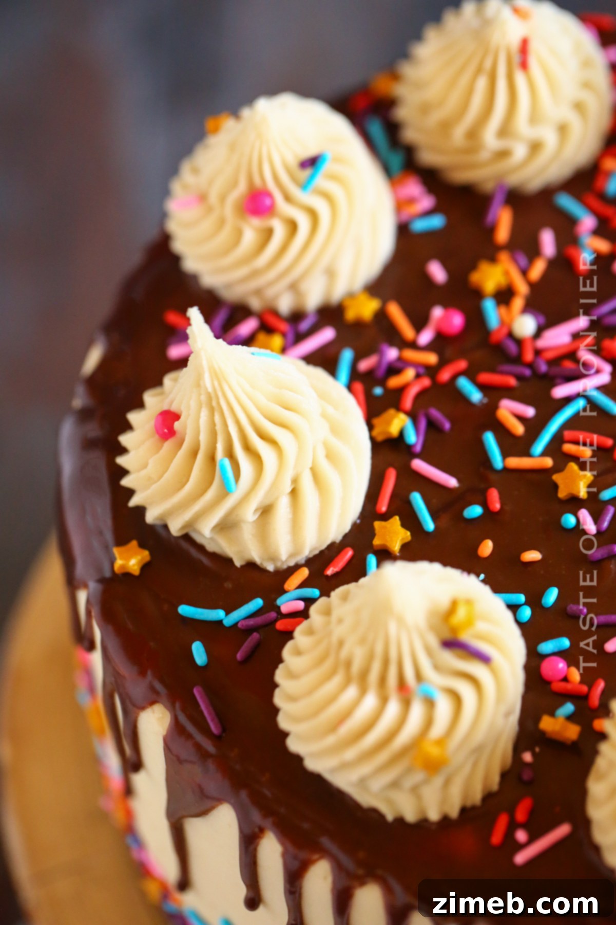 Close-up of elegant chocolate drip on a layered cake, showcasing the smooth, rich ganache.