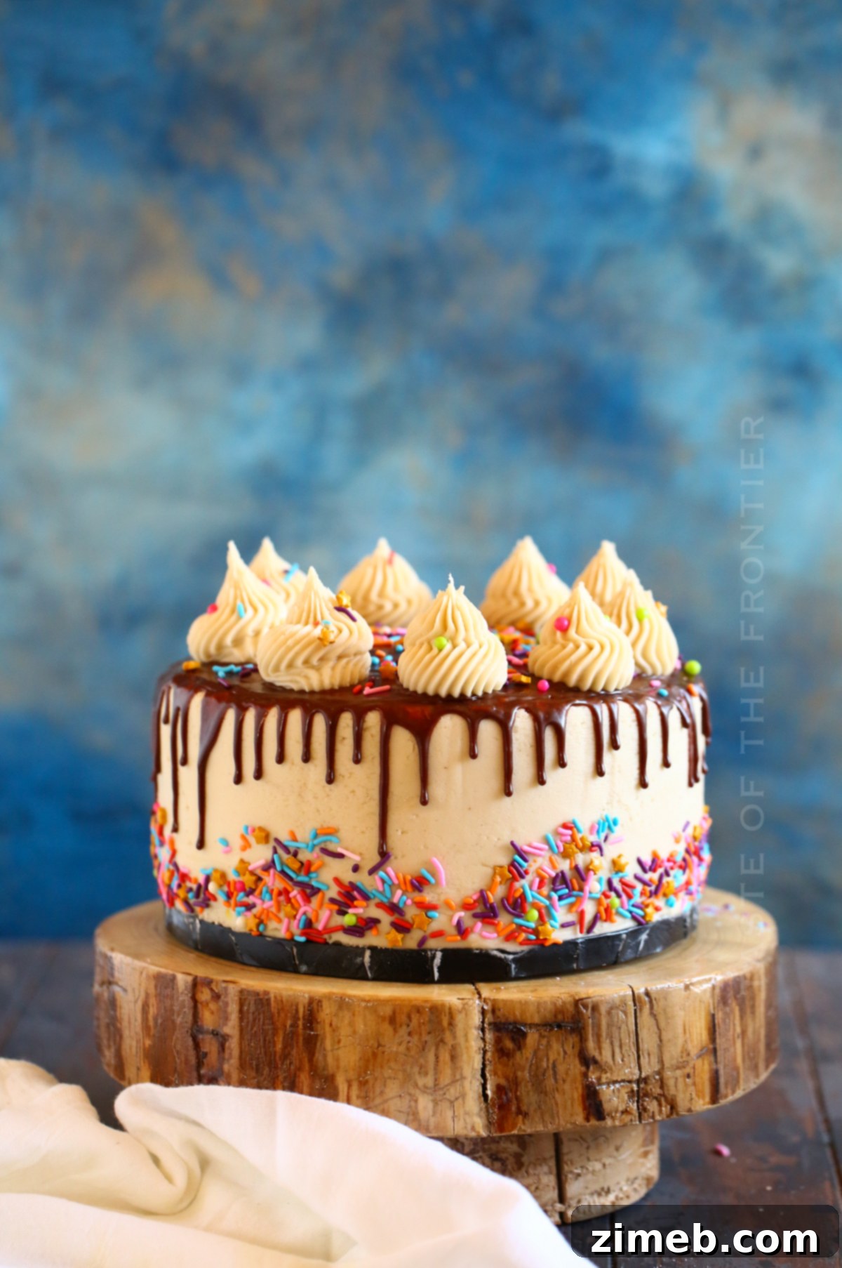 Close-up of rich milk chocolate drip descending elegantly on a cake, highlighting texture.
