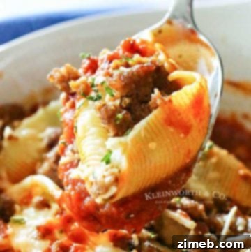 Effortless Slow Cooker Chicken Parmesan 10 A close-up of stuffed pasta shells filled with a creamy ricotta mixture, topped with marinara sauce and melted cheese.