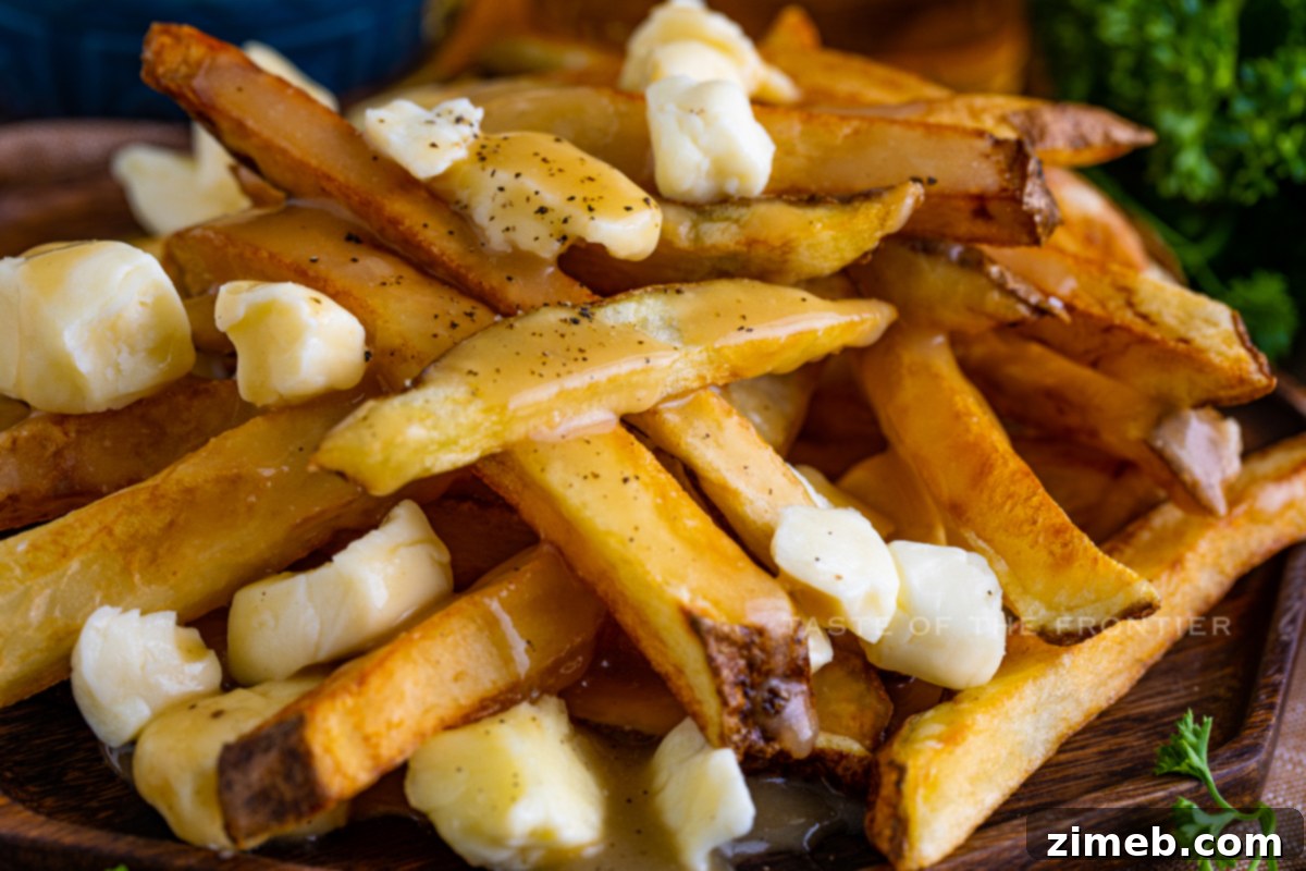 Poutine: Canada's Cheesy, Gravy-Laden Delight 10 Poutine snack served in a bowl with crispy fries, gravy, and curds