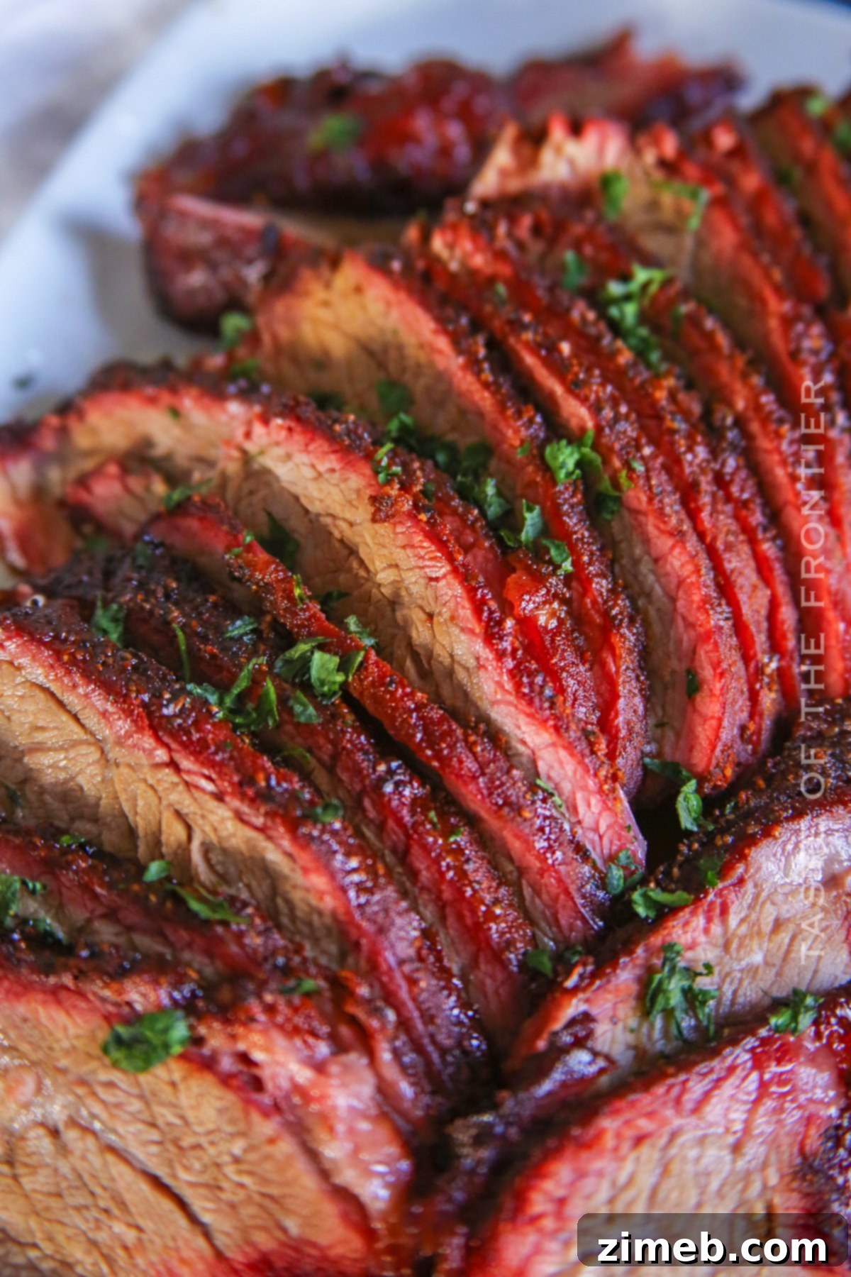 Close-up of a Smoked BBQ Roast, showcasing its dark bark and juicy interior, perfect for a Traeger.