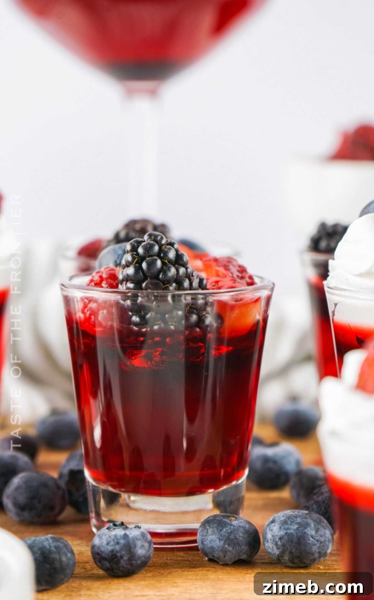 Red White And Boozy Jellies 2 4th of July Jello Shots with berries and whipped cream