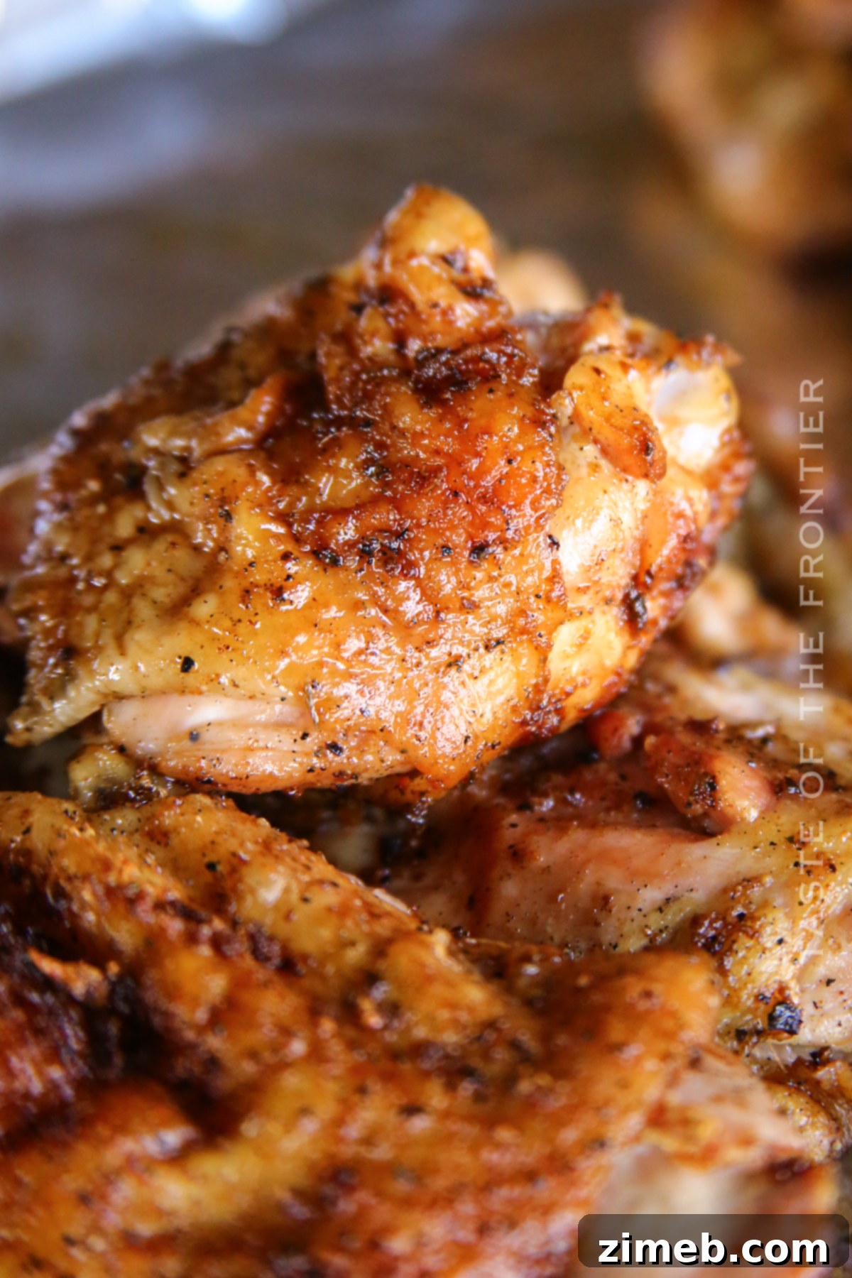 Juicy Smoked Chicken Thighs 20 Perfectly grilled BBQ chicken thighs, showcasing their delicious glaze and tenderness