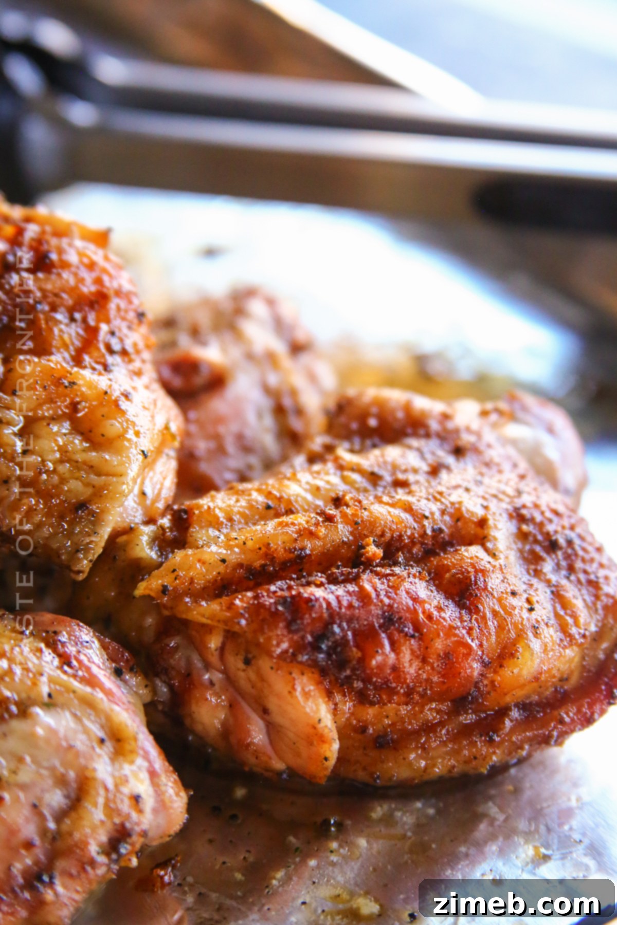 Juicy Smoked Chicken Thighs 5 A plate of freshly smoked chicken thighs from a pellet grill, ready to be served