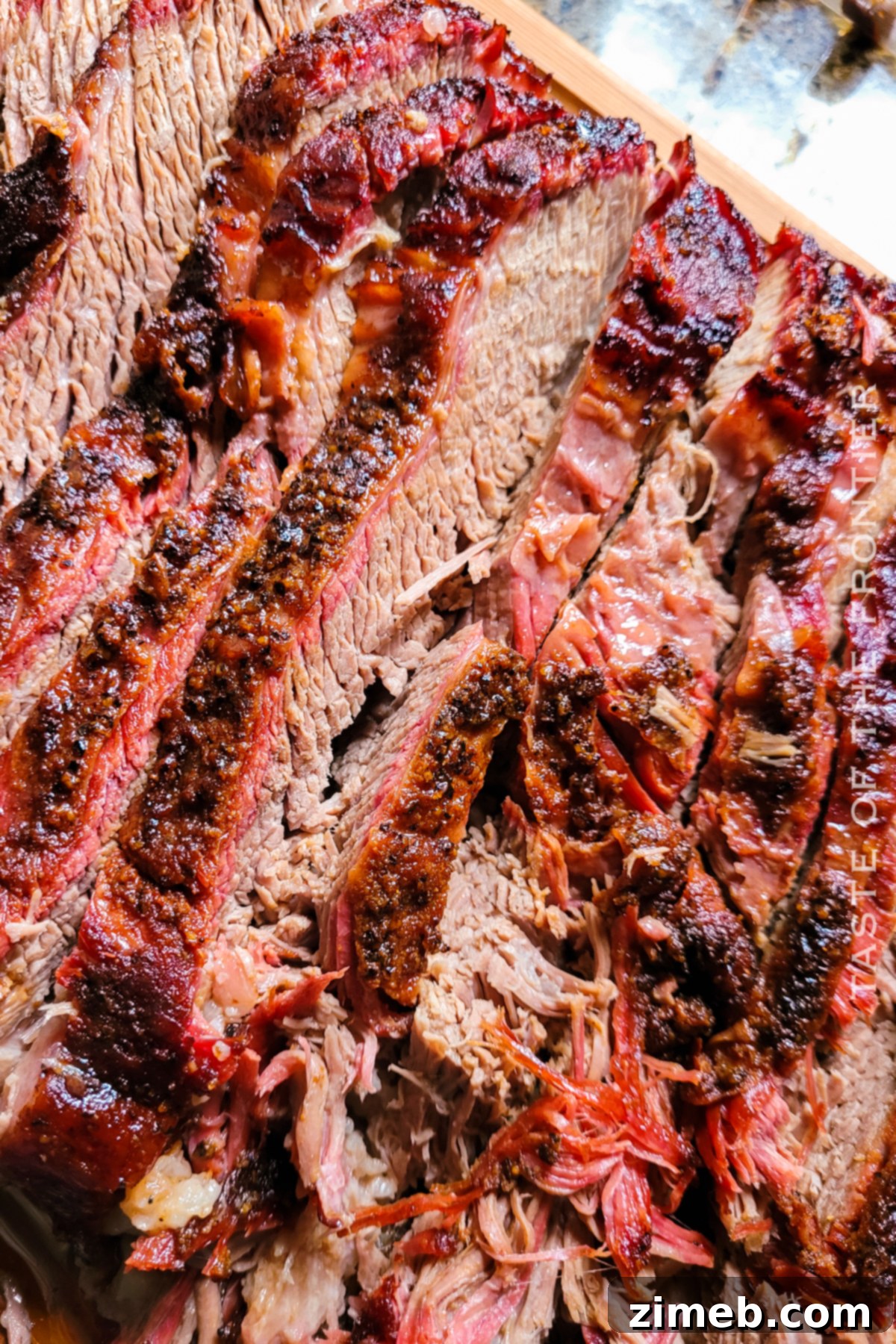 Slow-Smoked Brisket Perfection 4 A serving of Smoked Beef Brisket with a side of corn and macaroni salad.