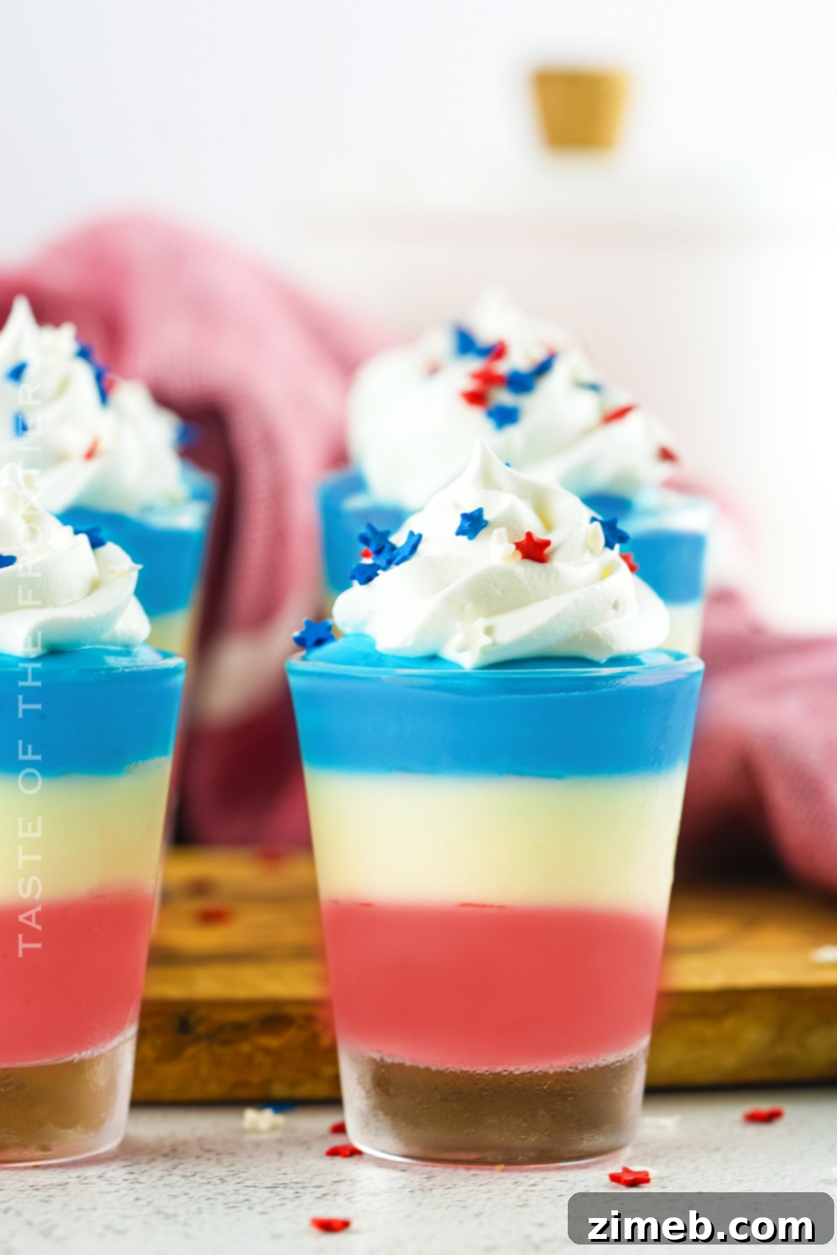Boozy Pudding Delights 20 Close-up of vibrant Pudding Shots, beautifully layered and ready to serve at an adult party.