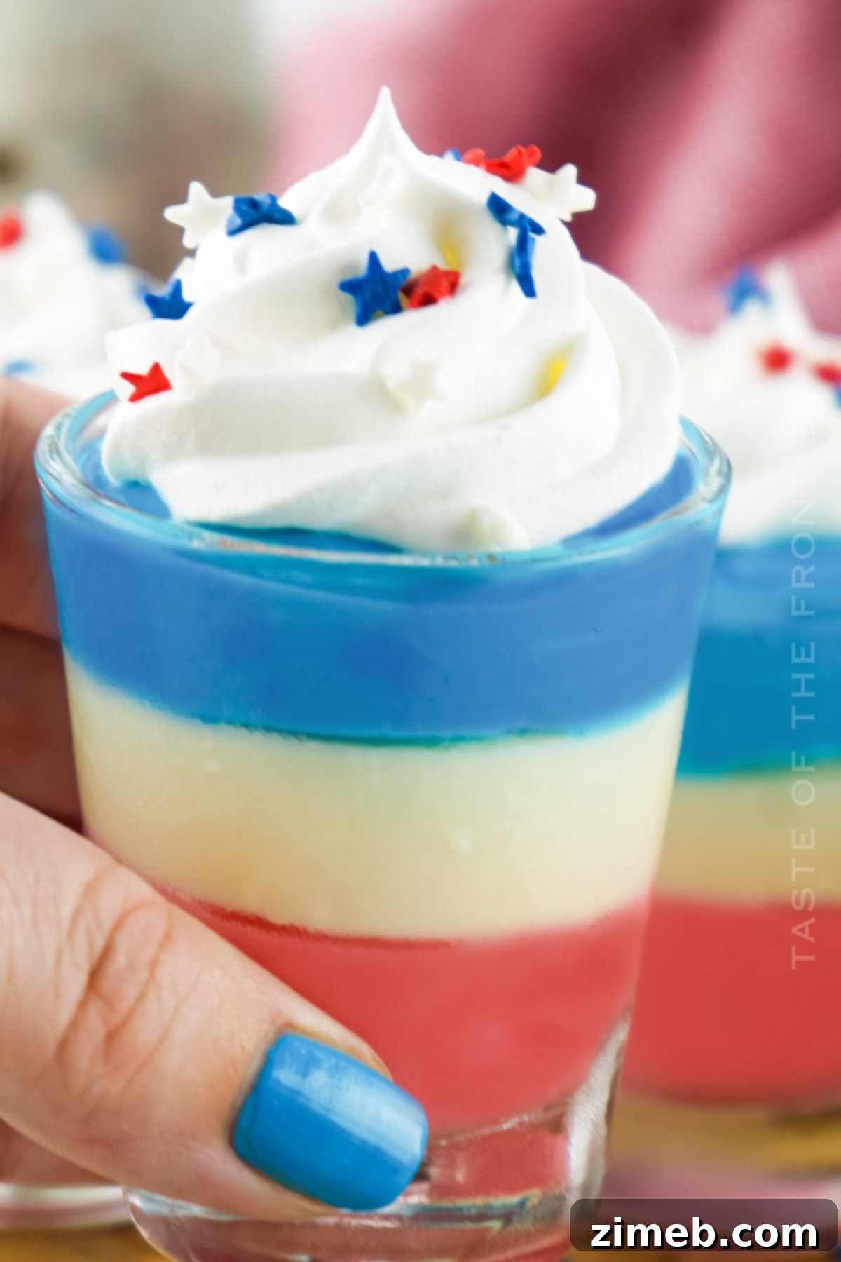 Boozy Pudding Delights 4 Festive Red, White, and Blue Pudding Shots arranged for a summer holiday party, showcasing their vibrant layers.