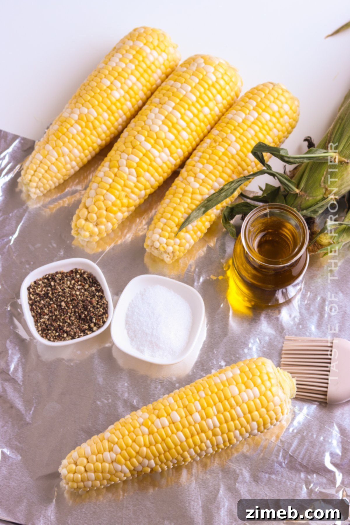 Deliciously Simple Grilled Corn 6 Preparing corn on the cob for grilling in foil
