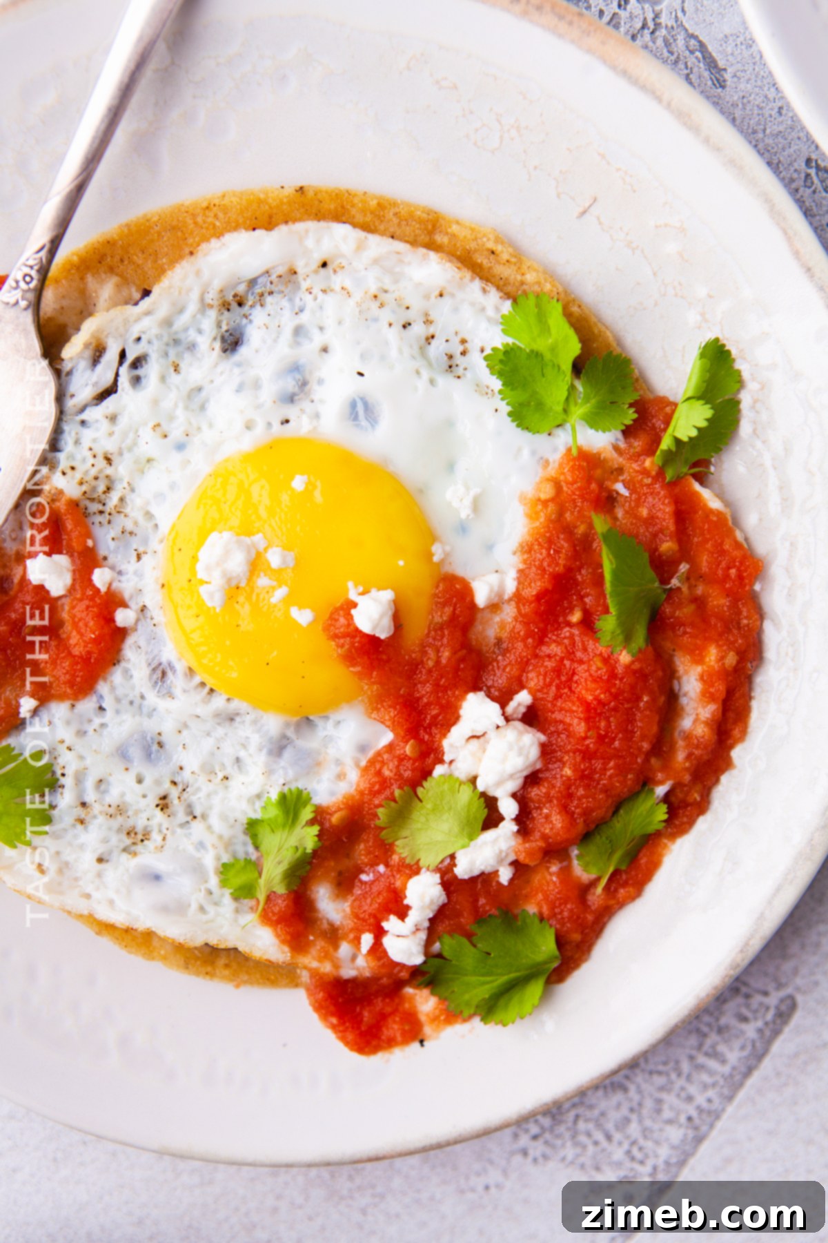Mexican Ranch Eggs 2 Classic Huevos Rancheros served on a rustic wooden table with fresh ingredients