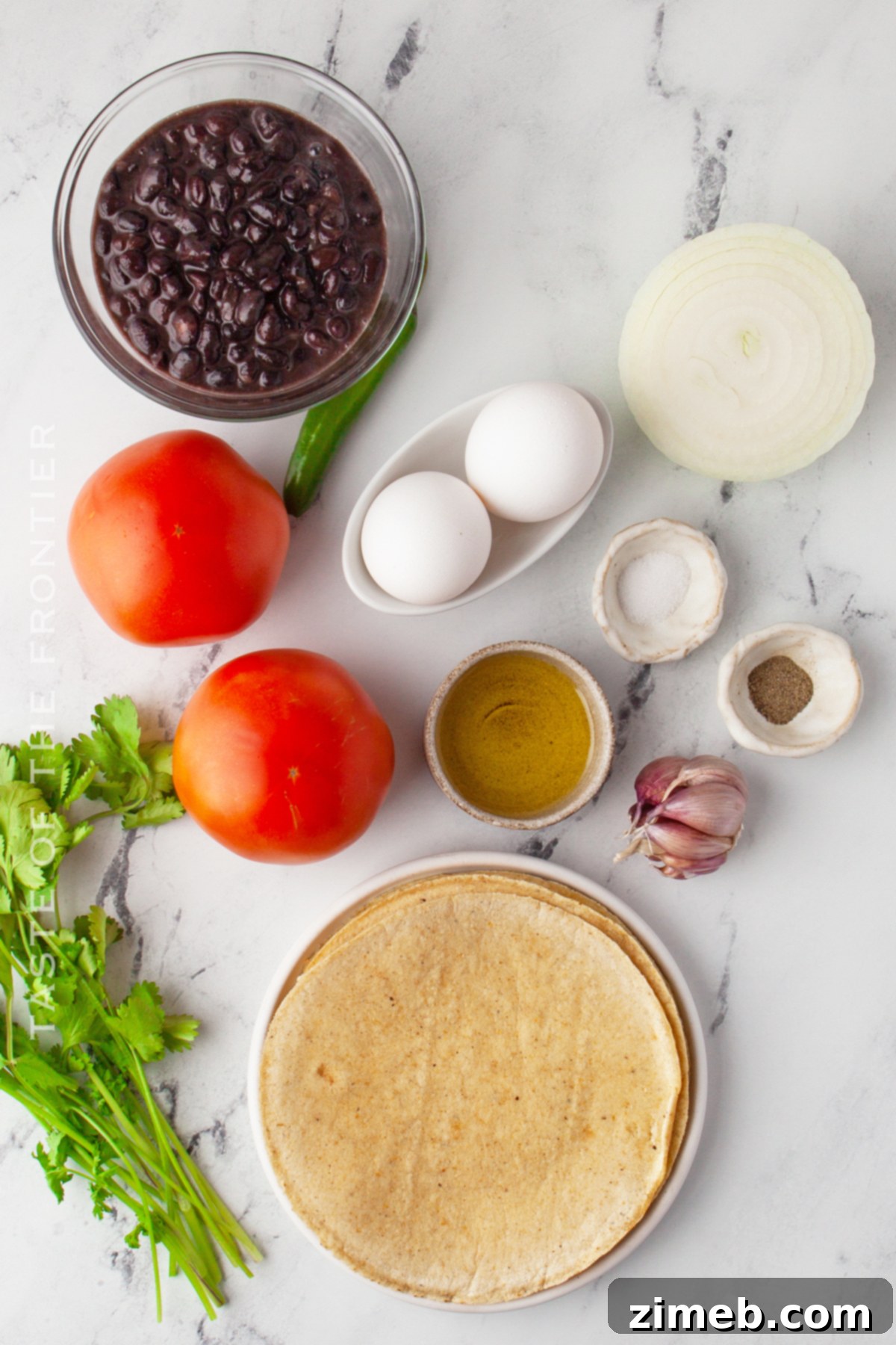 Mexican Ranch Eggs 4 Fresh ingredients laid out for making Huevos Rancheros: tomatoes, eggs, tortillas, cilantro