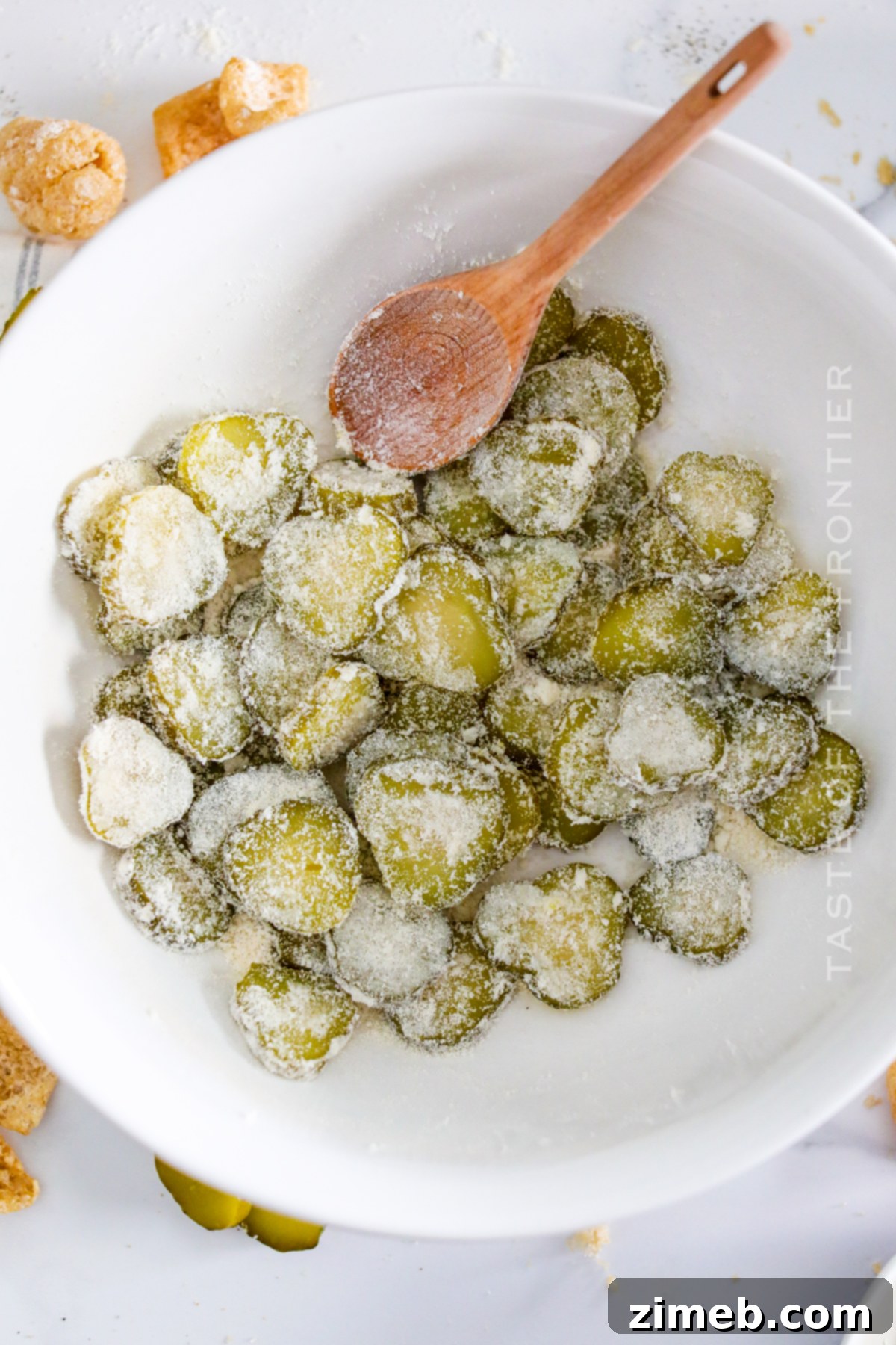 How to make Air Fryer Fried Pickles, showing the pickles arranged in the air fryer basket.