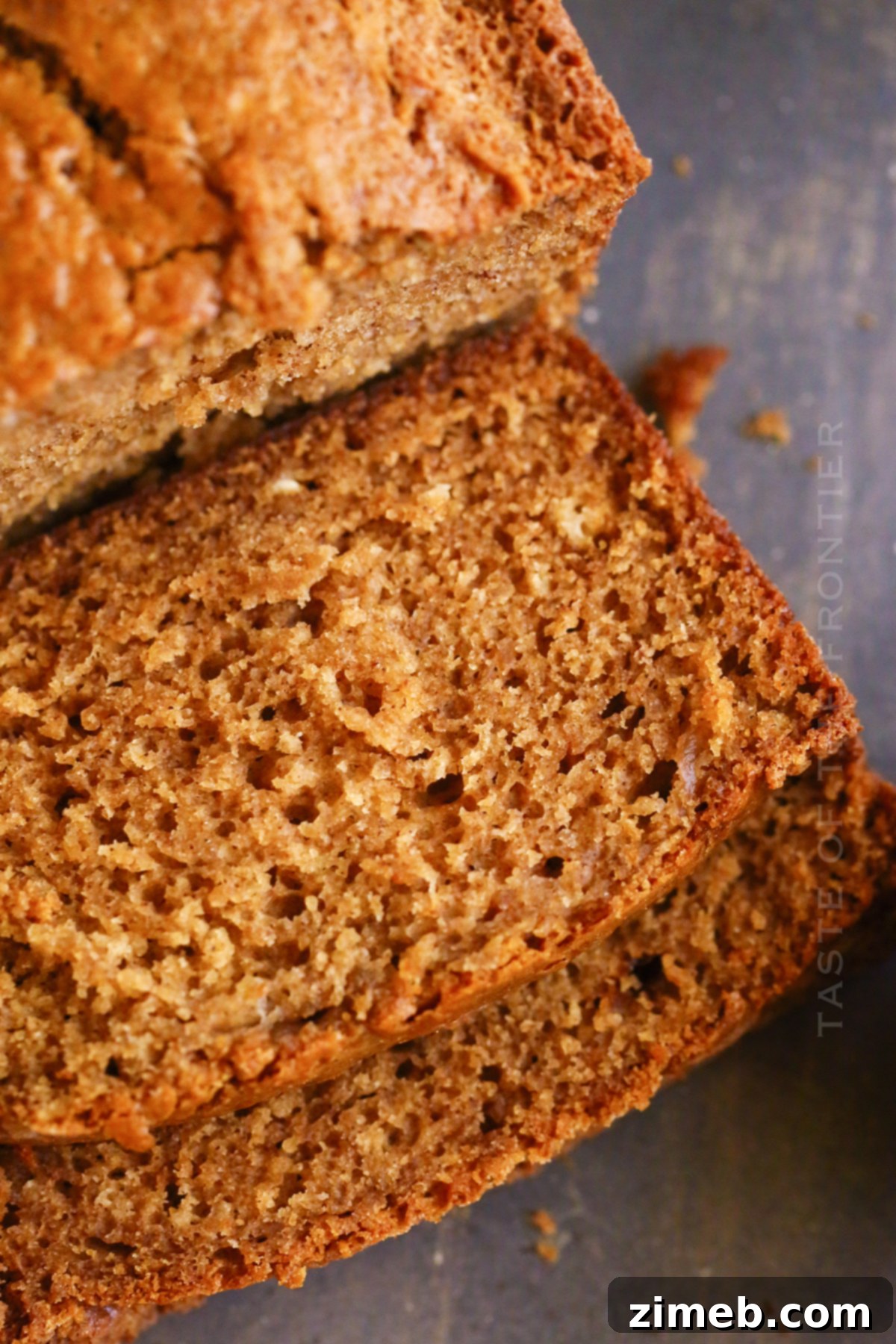 A slice of quick bread featuring apple cinnamon flavors