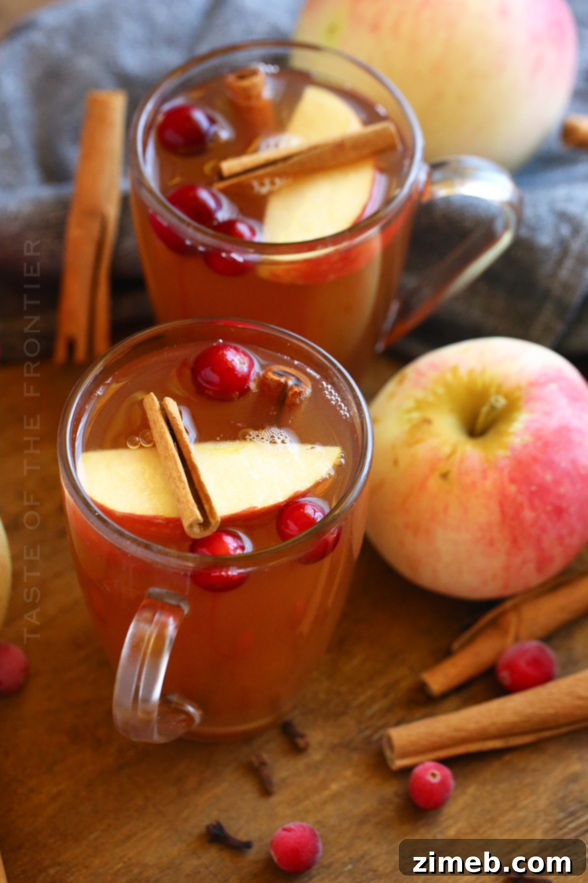 Thanksgiving Apple Cider served in mugs with cinnamon sticks, perfect for holiday tables.