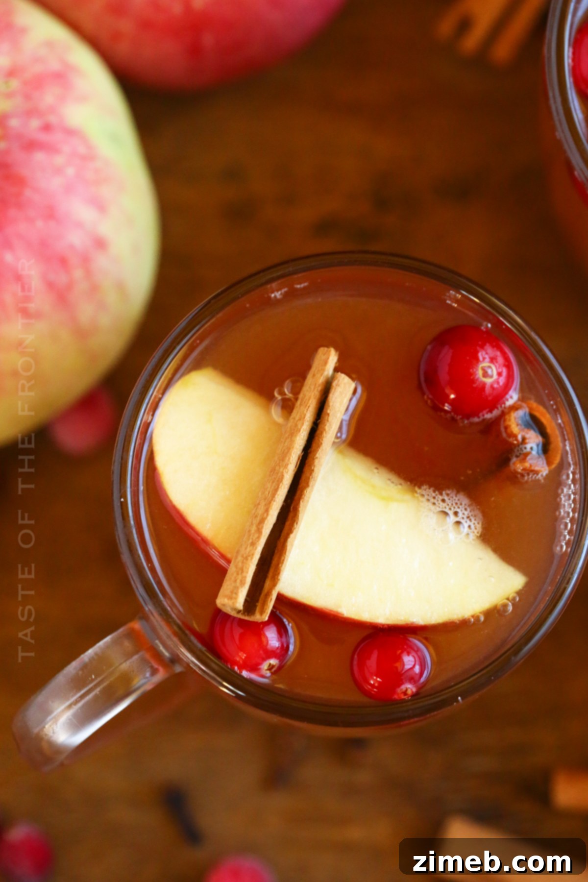 Pressure Cooker Apple Cider being strained into a pitcher, showing the final steps.