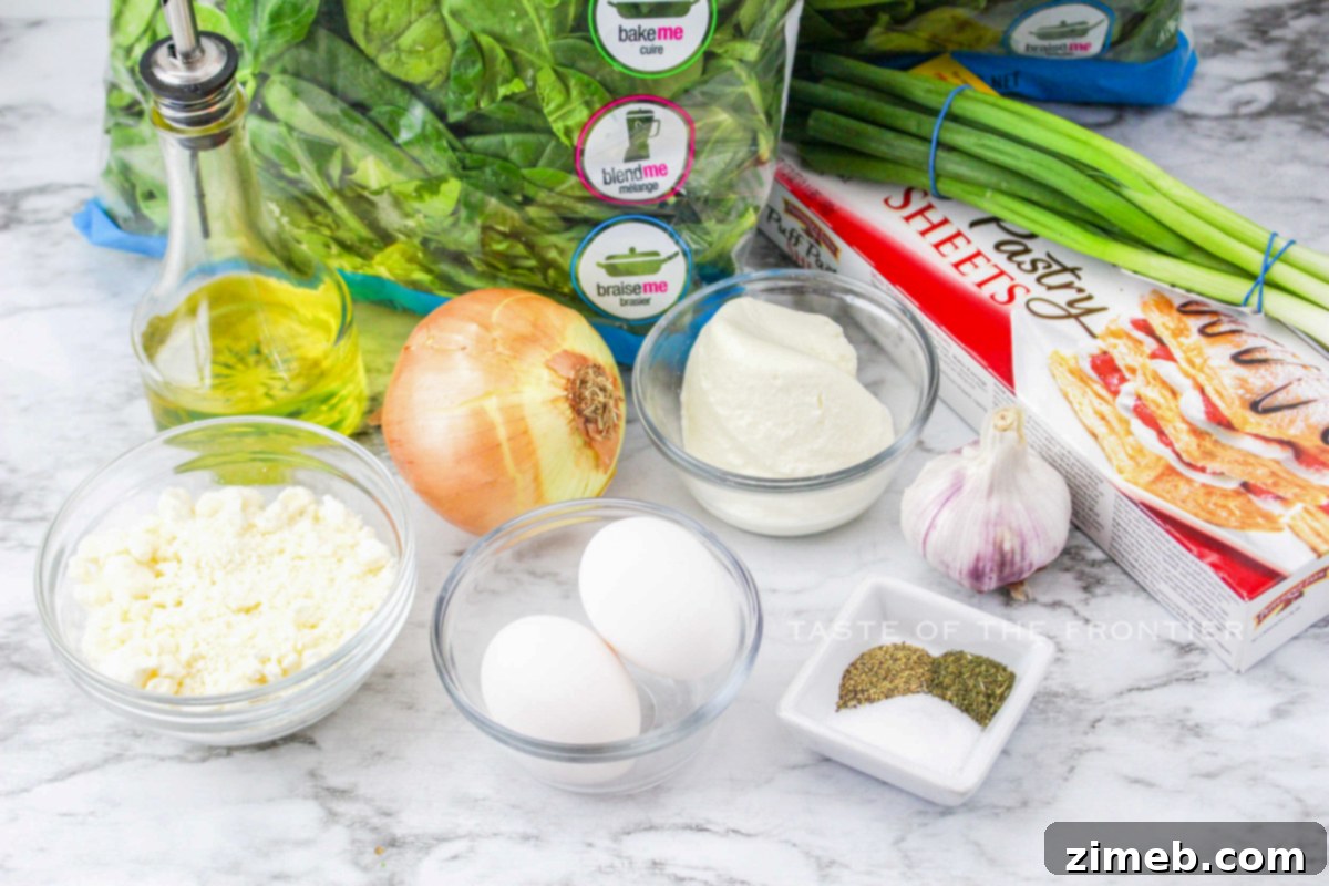 Ingredients for Spanakopita Recipe - Fresh spinach, feta, and puff pastry are key.