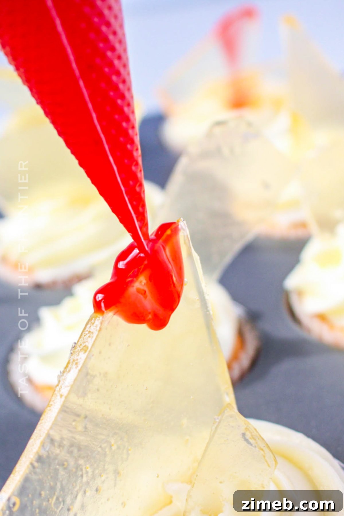 Adding corn syrup 'blood' for the Halloween cupcake decoration