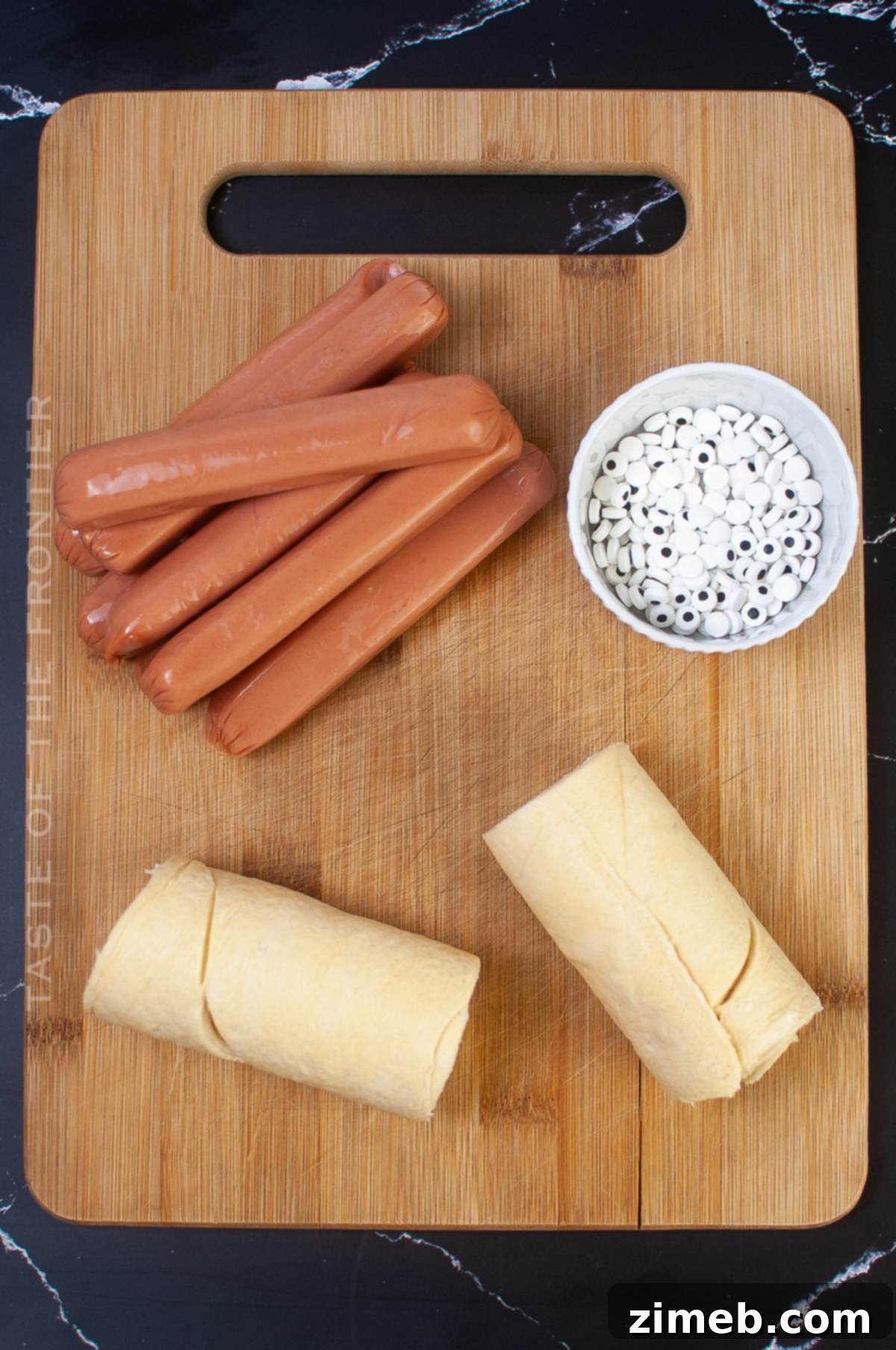 Phantom Franks 4 Ingredients for making Mummy Dogs: hot dogs, crescent rolls, and candy eyeballs.