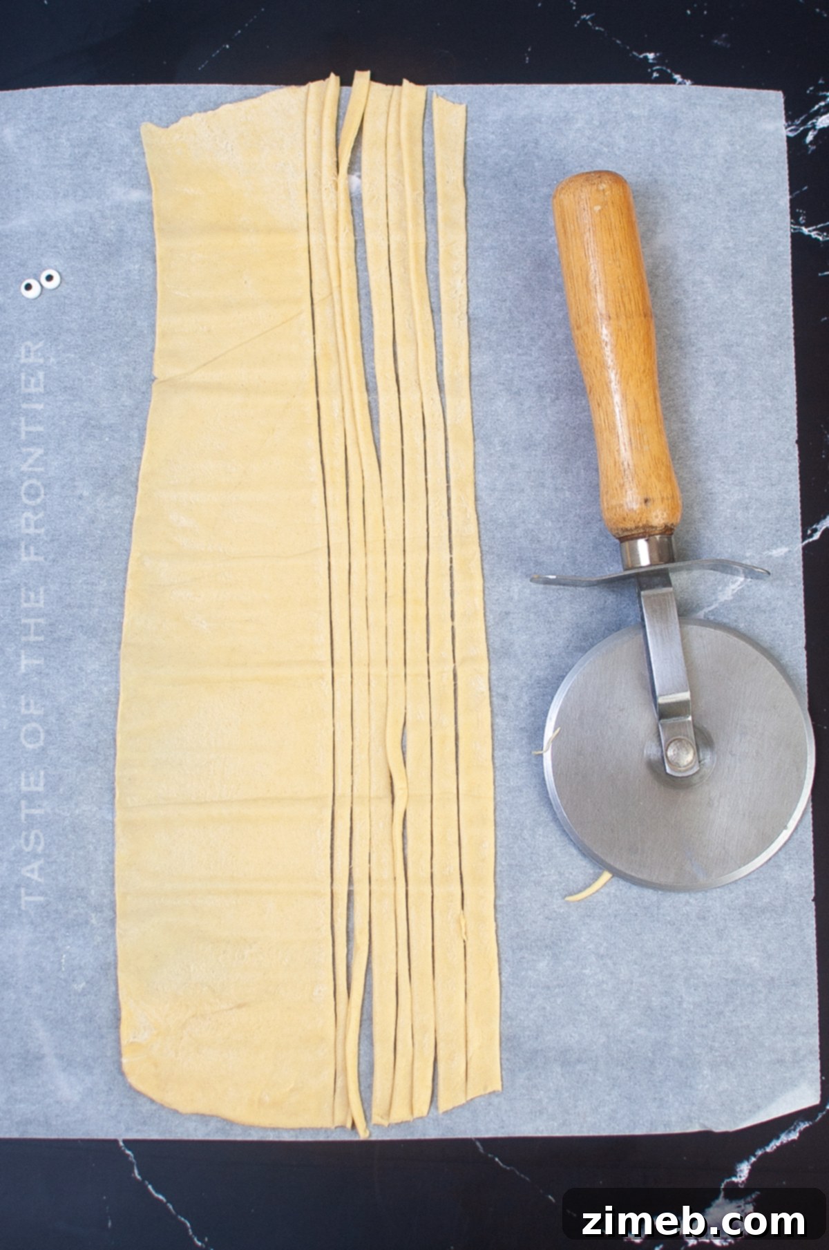 Phantom Franks 5 Process of cutting crescent roll dough into strips for wrapping hot dogs.