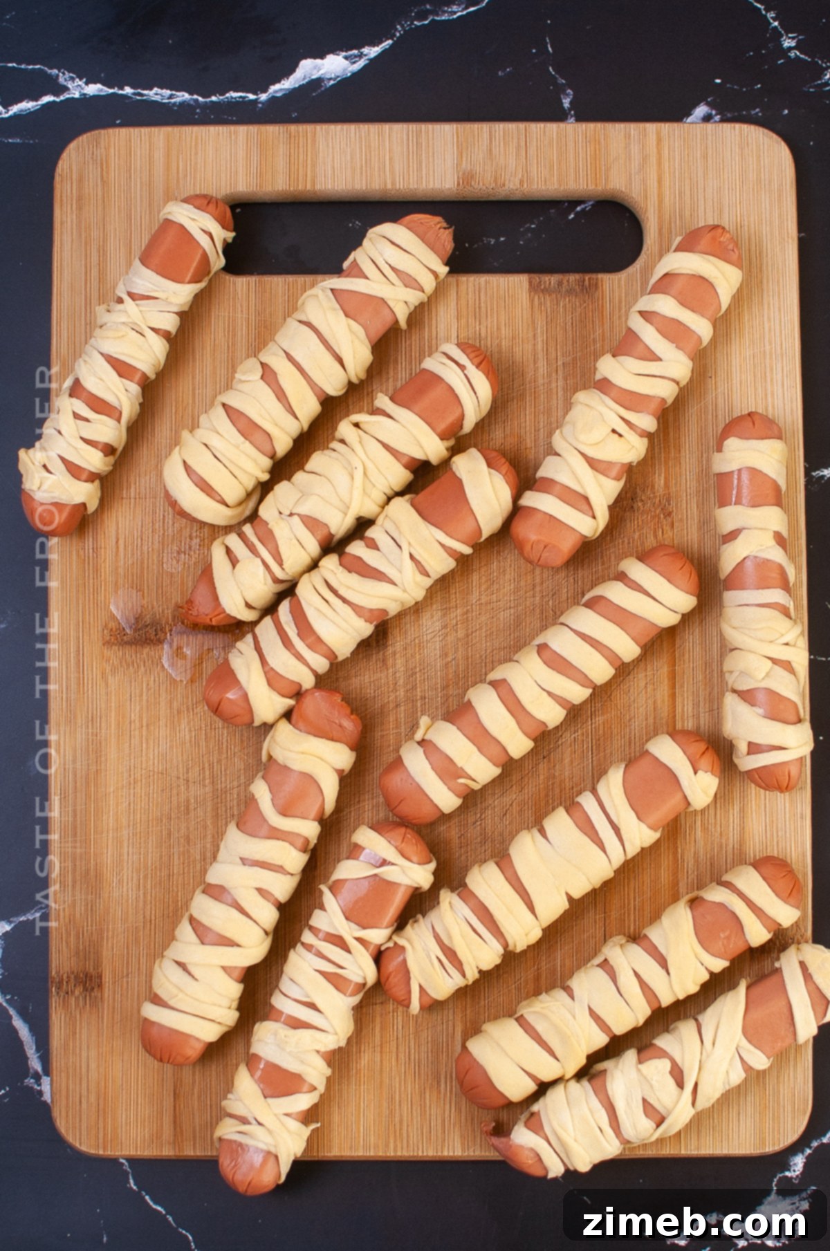 Phantom Franks 7 Hot dogs wrapped in dough, ready for baking – a festive Halloween dinner idea.