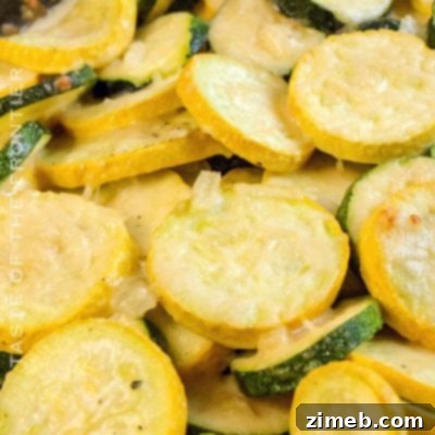 A creamy and cheesy Squash Casserole in a baking dish, ready to be served as a comforting side.