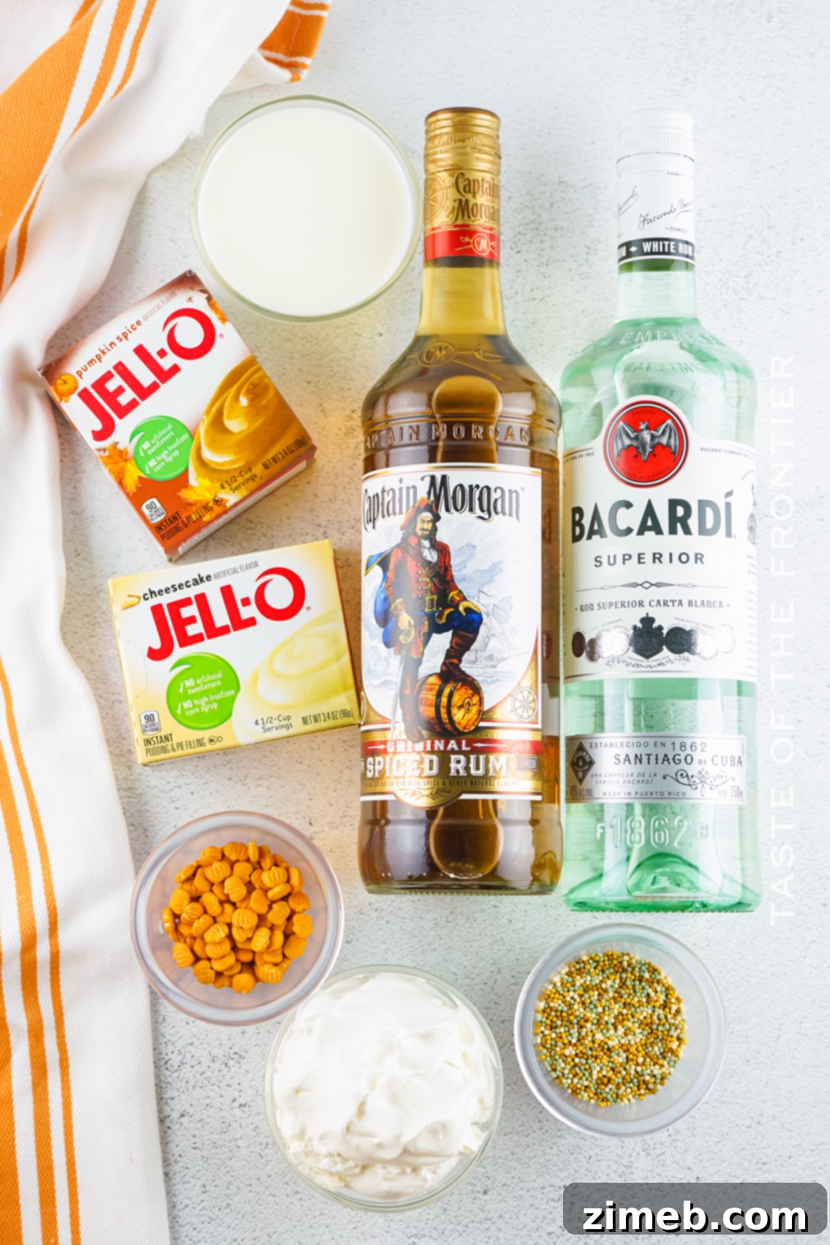 Ingredients for making Pumpkin Pudding Shots including pumpkin spice pudding, cheesecake pudding, rums, and half and half.