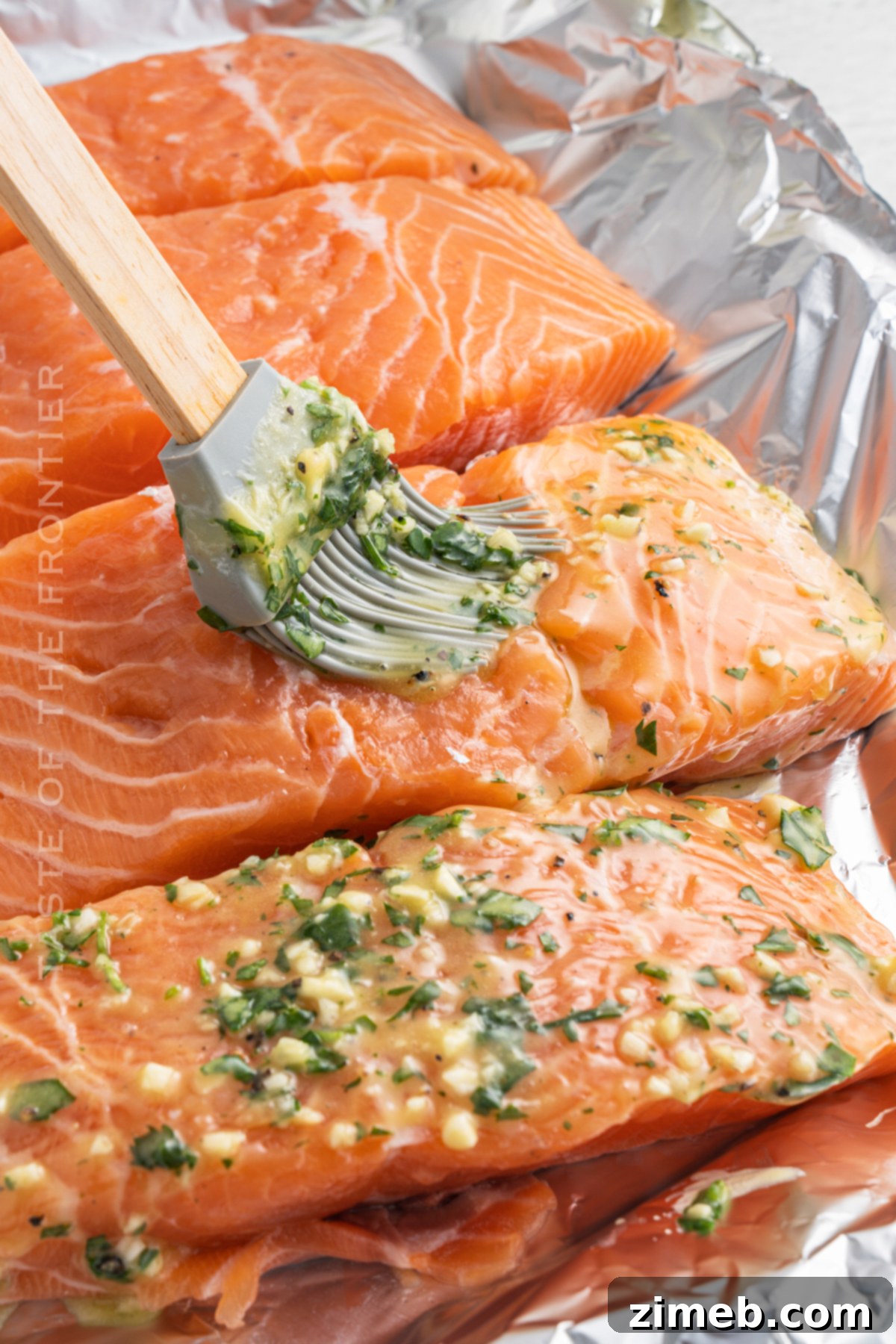 How to Bake Salmon: A prepared salmon fillet in foil with vegetables, ready for the oven, highlighted for clear instruction.