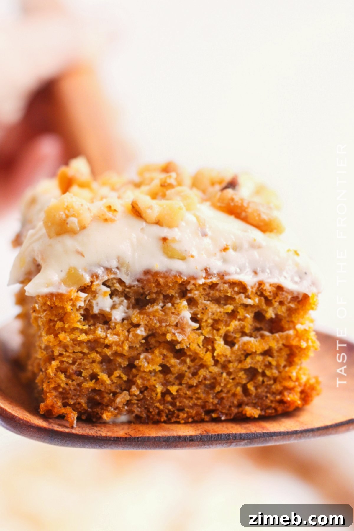 A perfectly baked, moist Pumpkin Spice Cake with fluffy cream cheese frosting, ready to be served.