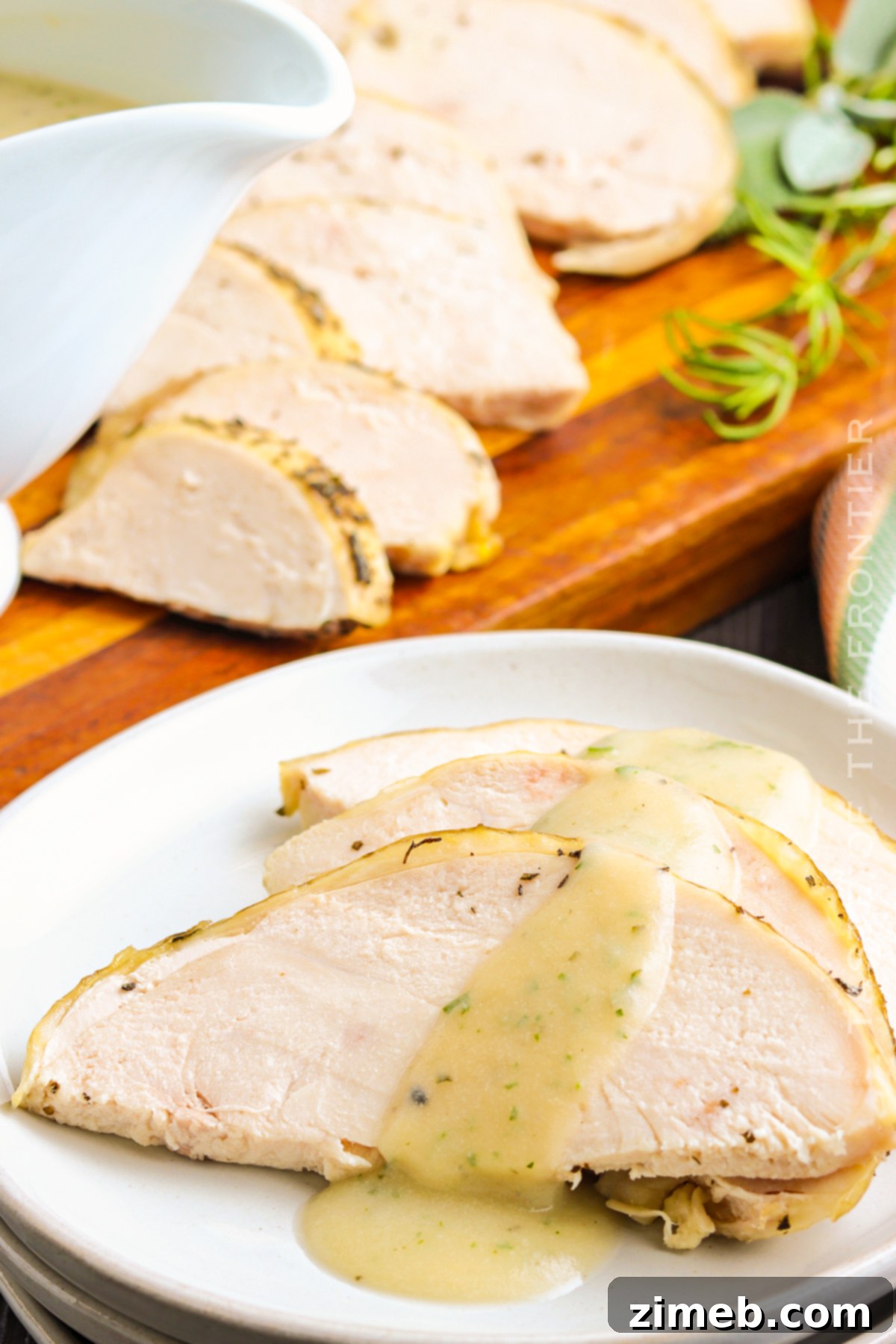 Perfectly sliced roasted turkey covered generously with homemade gravy, highlighting its appeal.