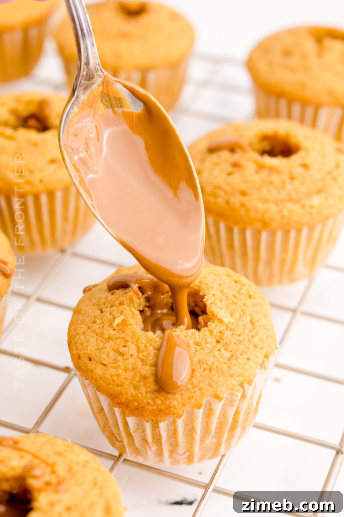 Lotus Biscoff Dream Cupcakes 6 Close-up of a Biscoff cupcake being filled with cookie butter, showing the gooey center