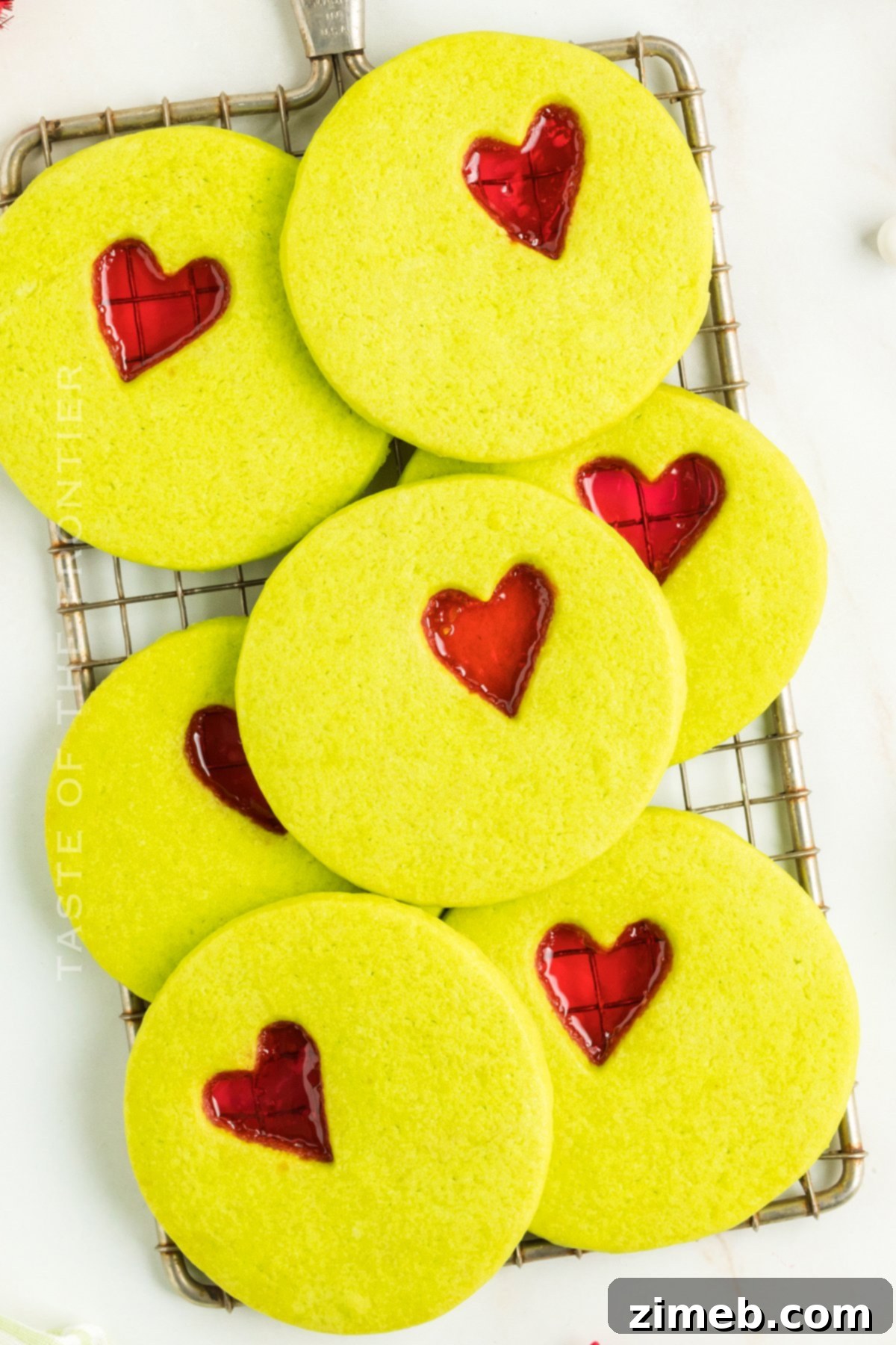 Recipe for Grinch Christmas Cookies, featuring green cookies with a red heart candy center.