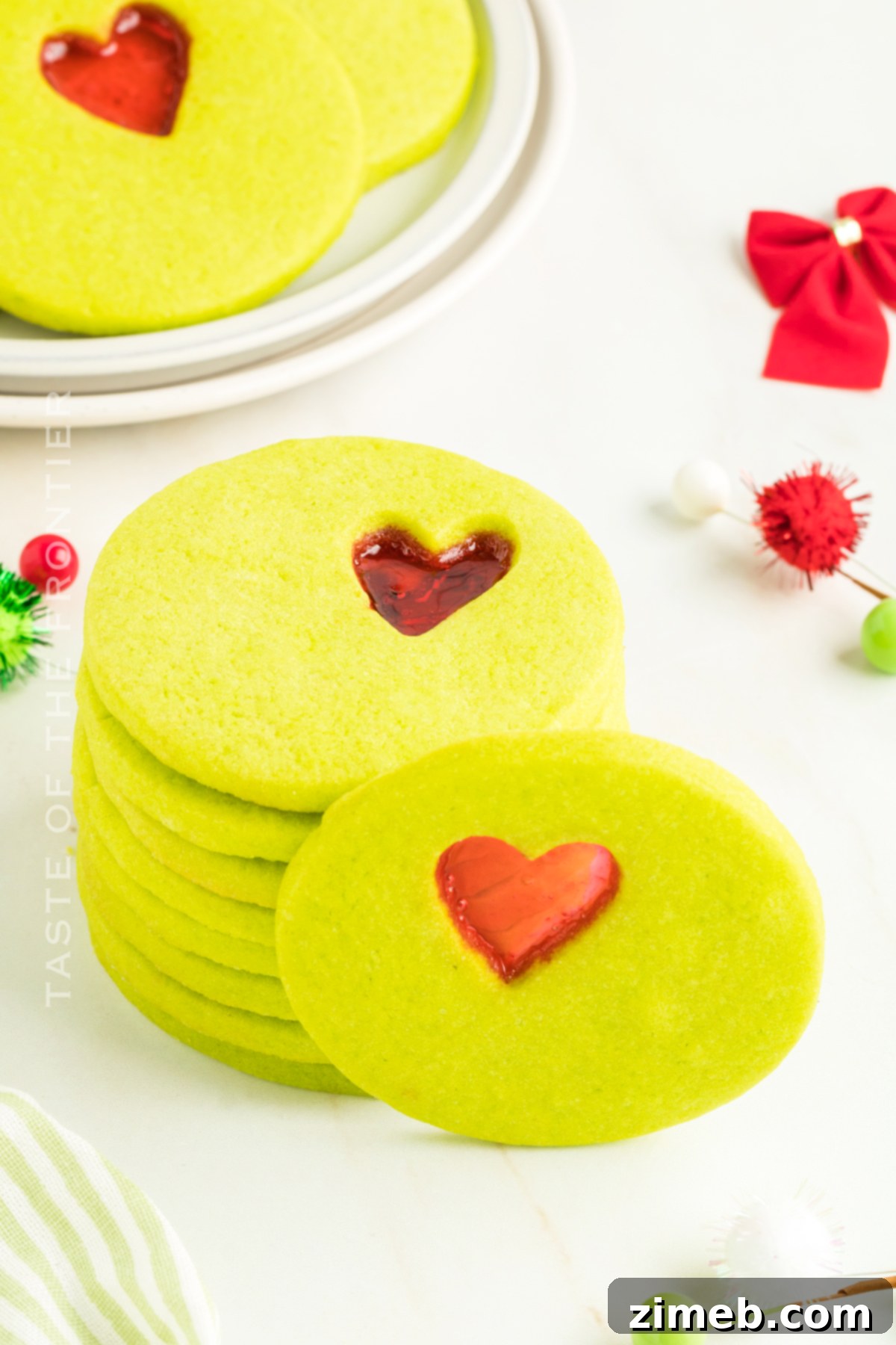 Assortment of festive Christmas Cookies, including Grinch cookies, on a platter.