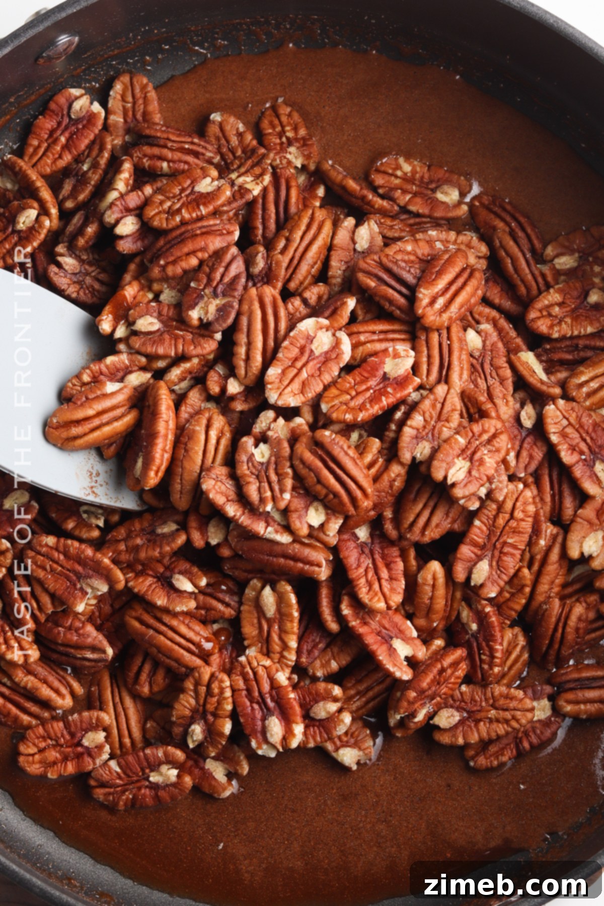 Sweet Glazed Pecans 6 Coating the nuts in sweet sauce - The key step to perfect candied pecans.