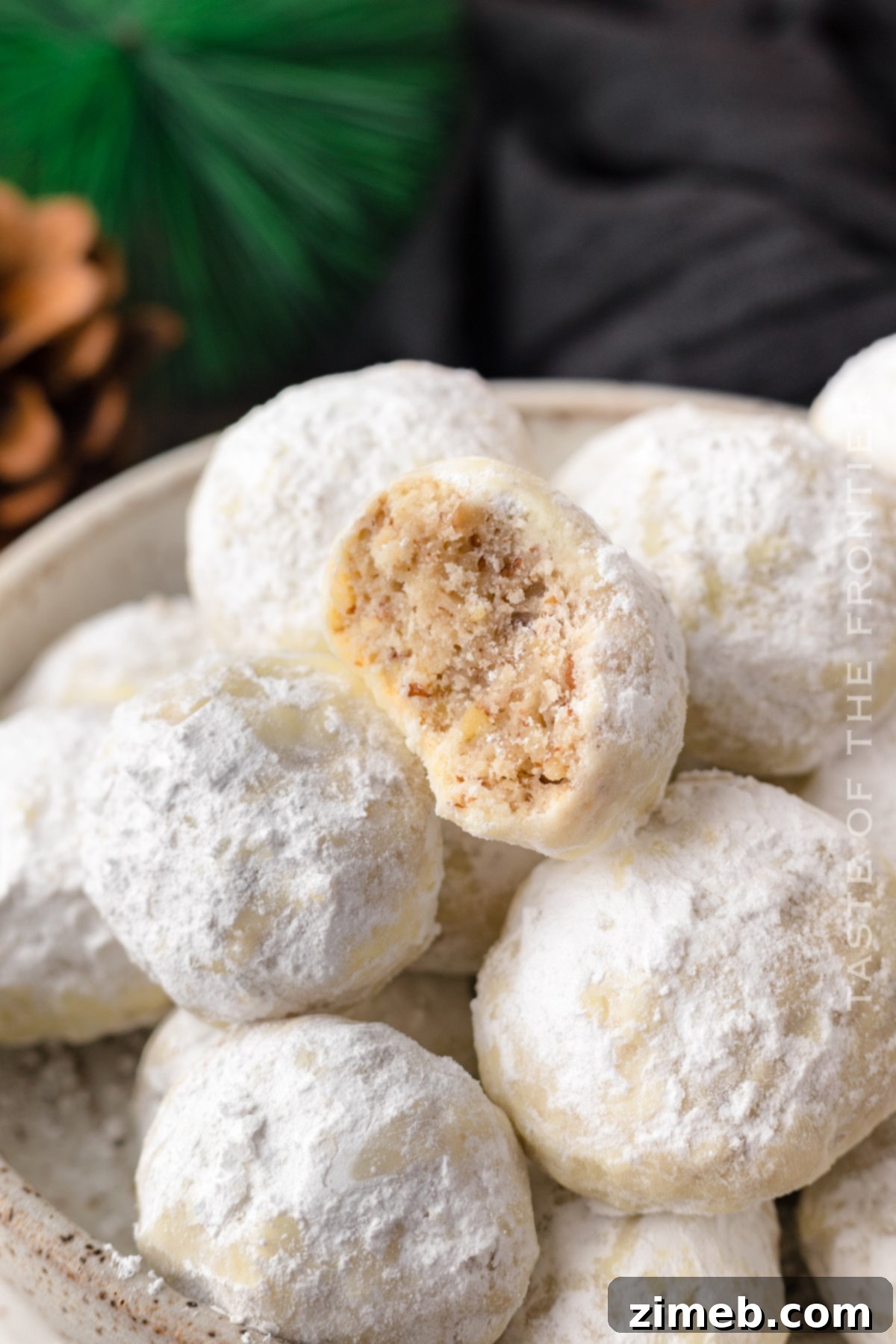Delicate Mexican Wedding Cookies dusted with powdered sugar, showcasing their buttery crumble and crushed pecans, perfect for holidays or special occasions.