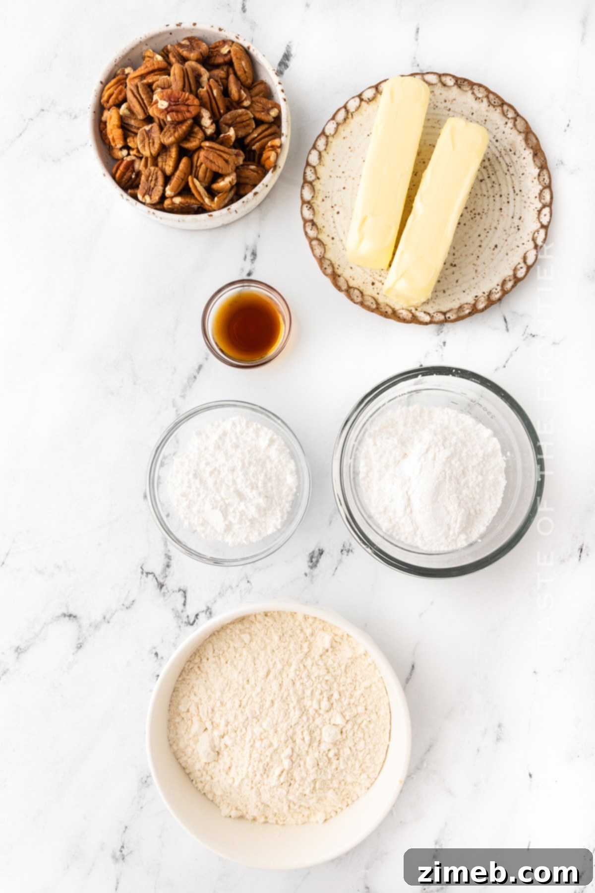 Ingredients for Easy Mexican Wedding Cookies or Snowball Cookies, including flour, pecans, butter, confectioner's sugar, and vanilla extract.