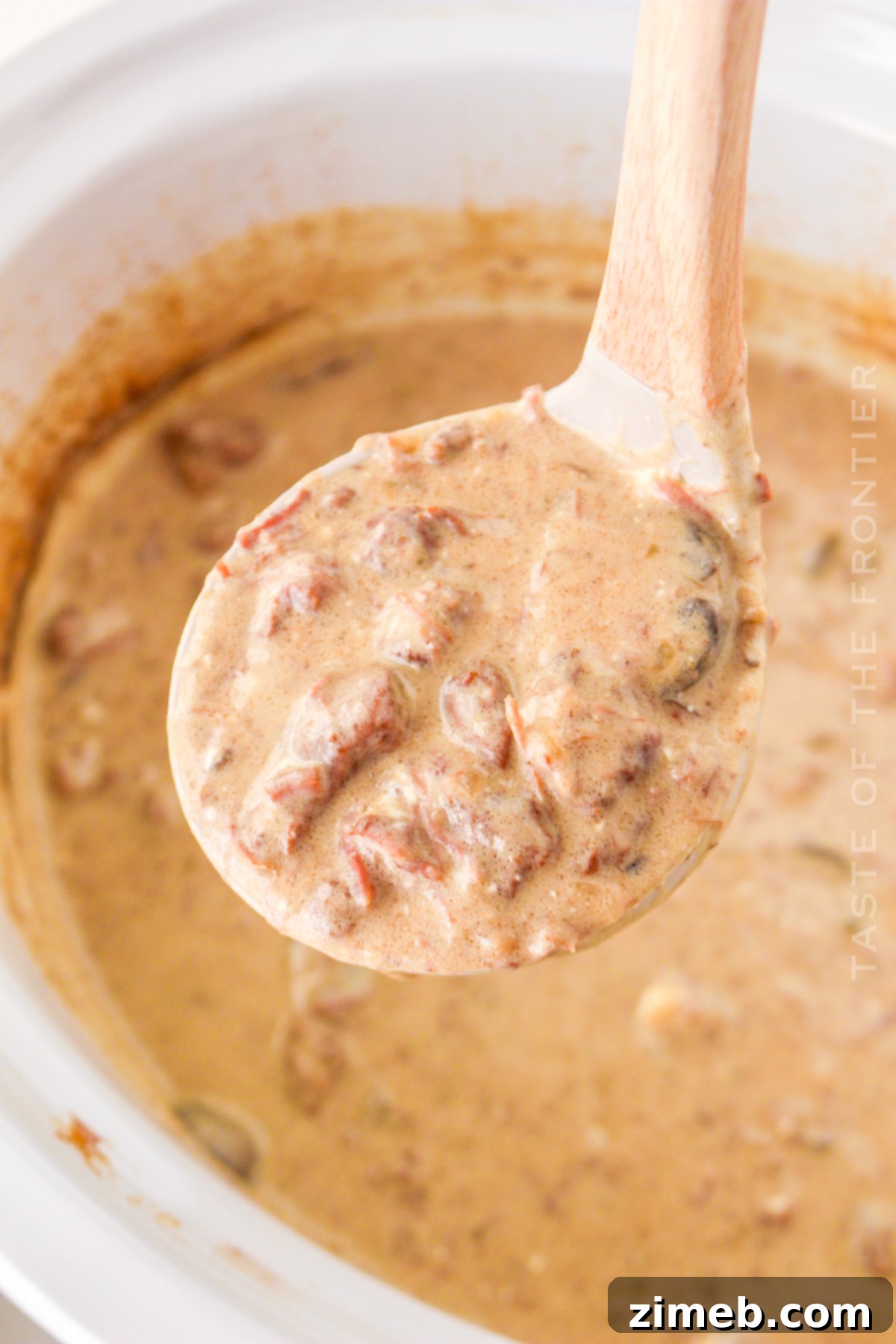 Cozy Comfort Slow Cooker Beef Stroganoff 17 Creamy beef stroganoff sauce in a slow cooker, perfectly cooked and ready to serve.