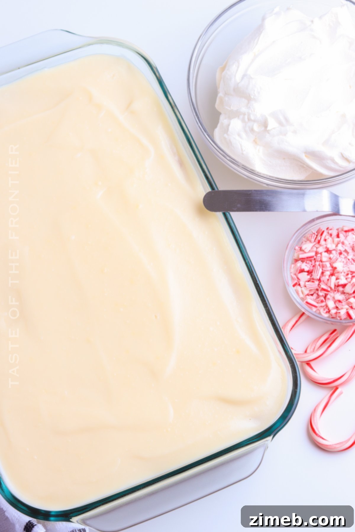 Festive Peppermint Cake 8 Peppermint Poke Cake before decorating with candy canes, showing pudding layer