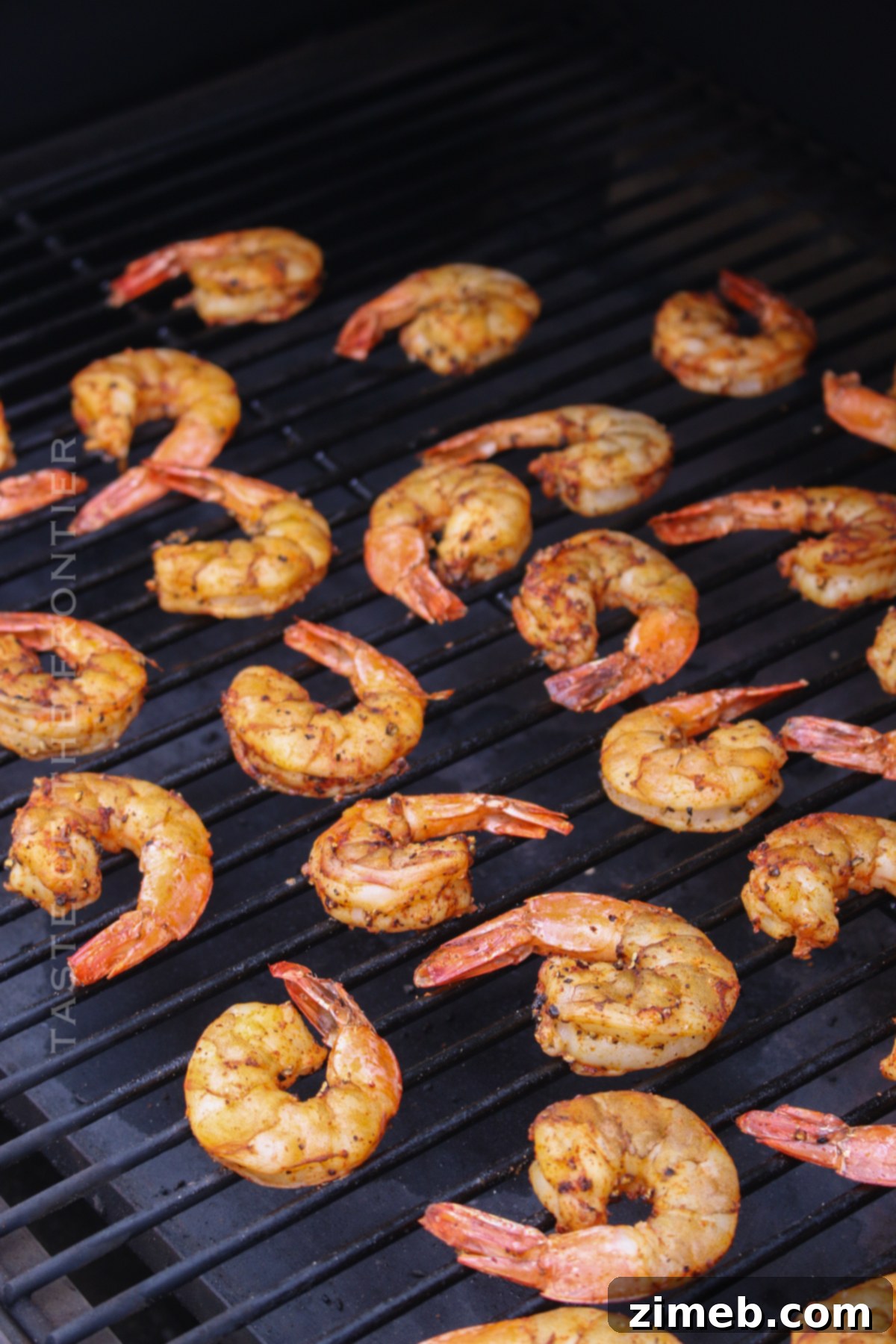 Savory Smoked Shrimp 7 Perfectly cooked and smoked shrimp resting on a Traeger grill grate, ready to be served.