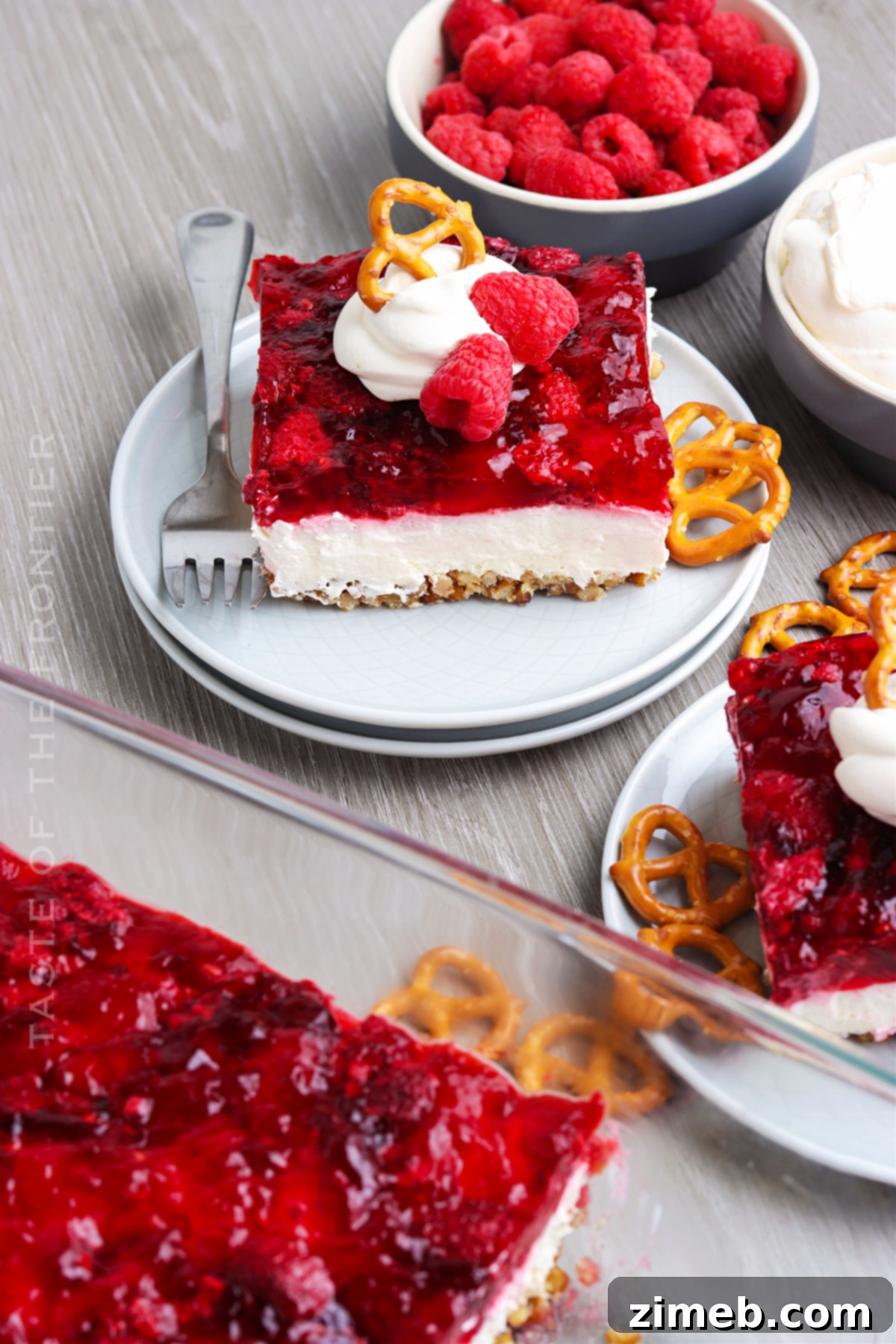 Salty Sweet Raspberry Dream 3 Vibrant Raspberry Pretzel Dessert for Holidays - A festive and easy layered treat with jello and cream cheese.
